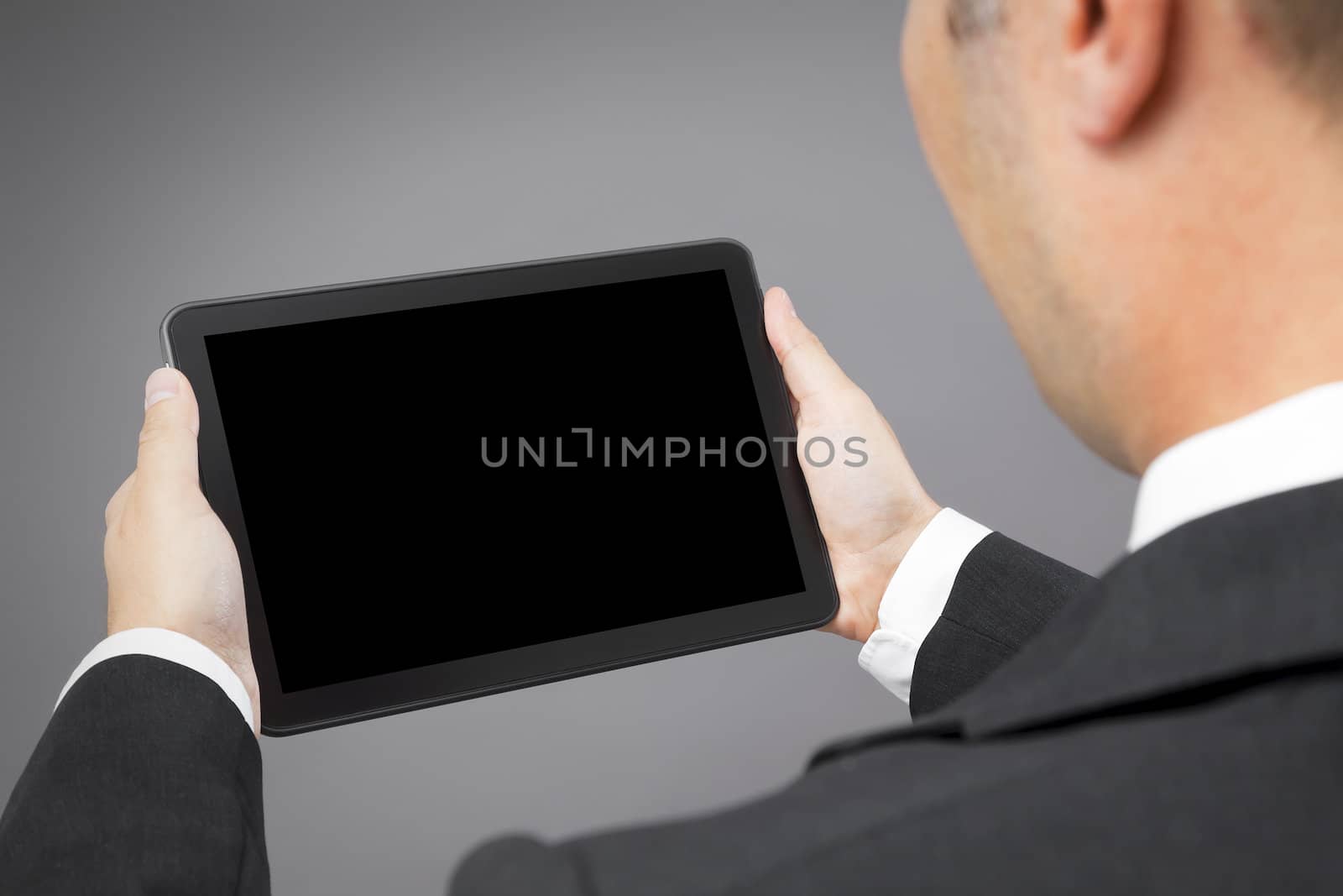 business man reading tablet pc by magann