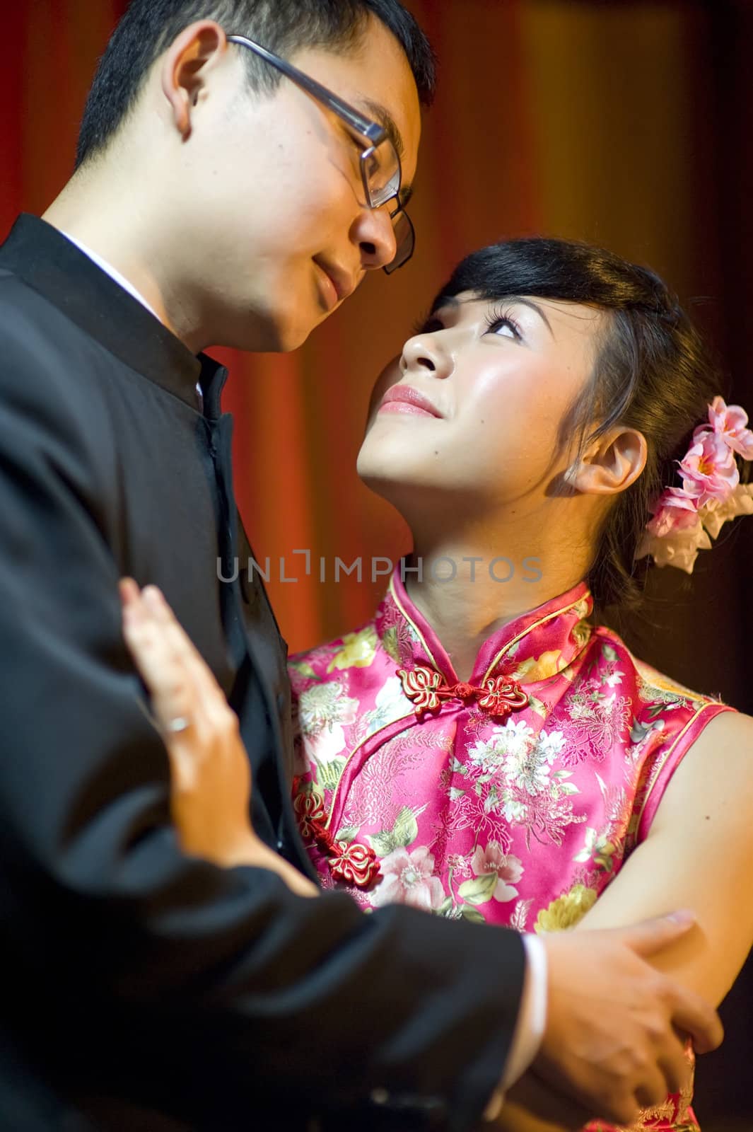 an affectionate young couple embracing before their wedding day by jackq