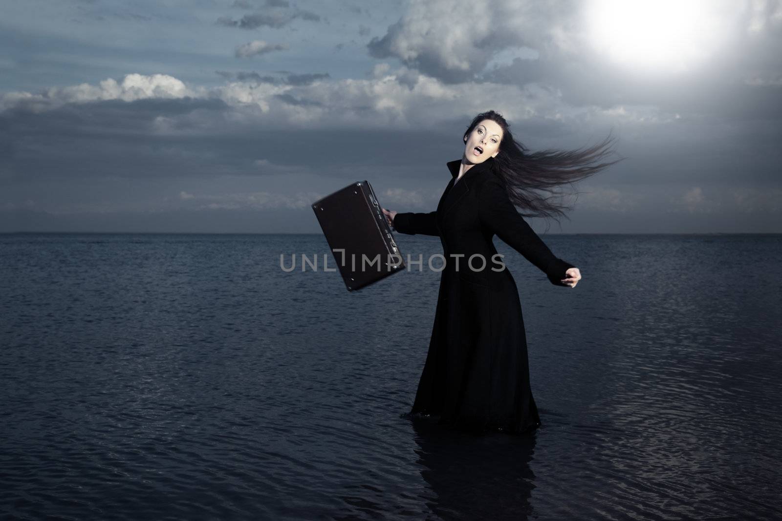 Screaming traveler with bag moving into the sea
