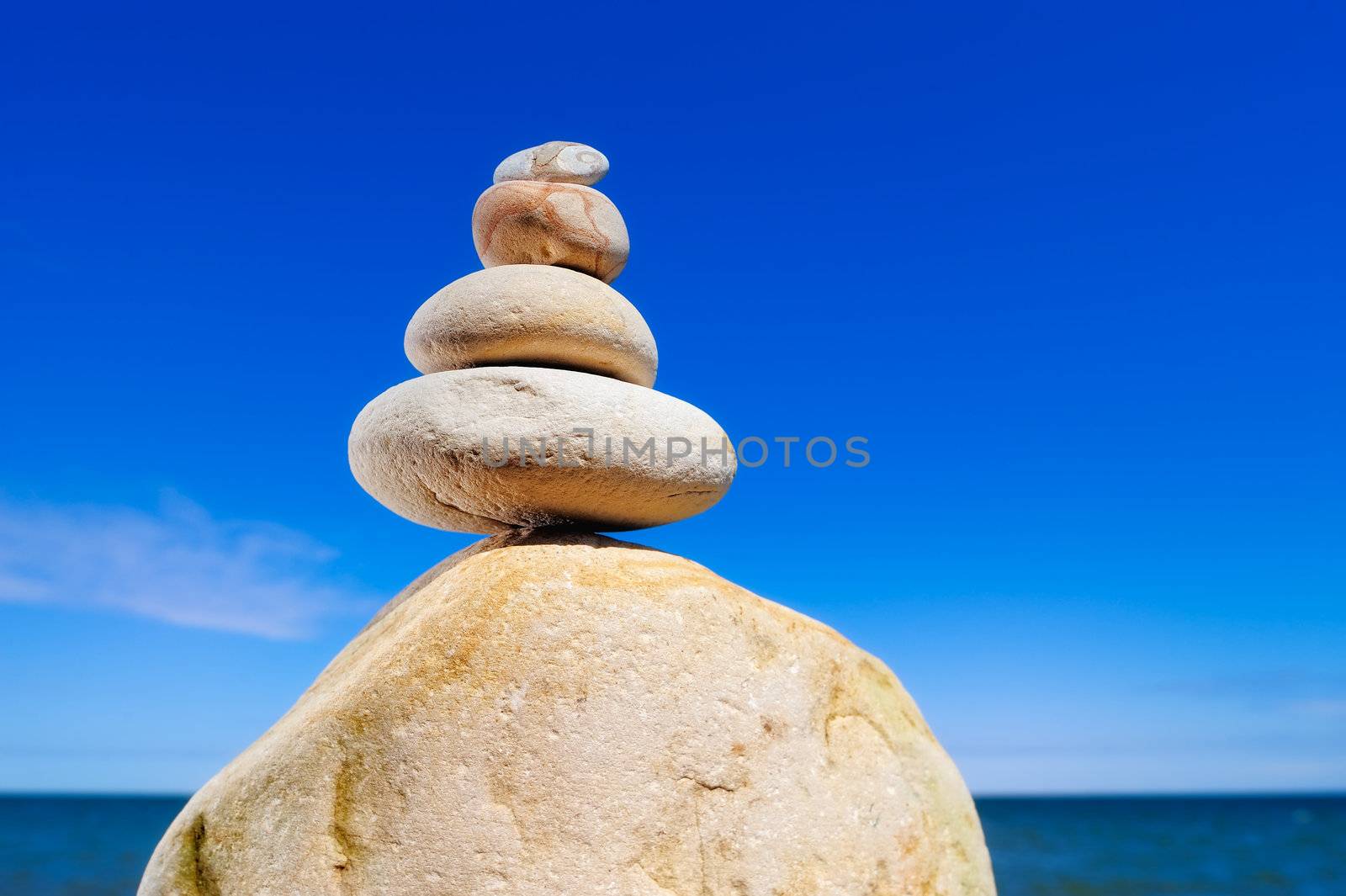 Pile of the yellow pebble on background the blue sky