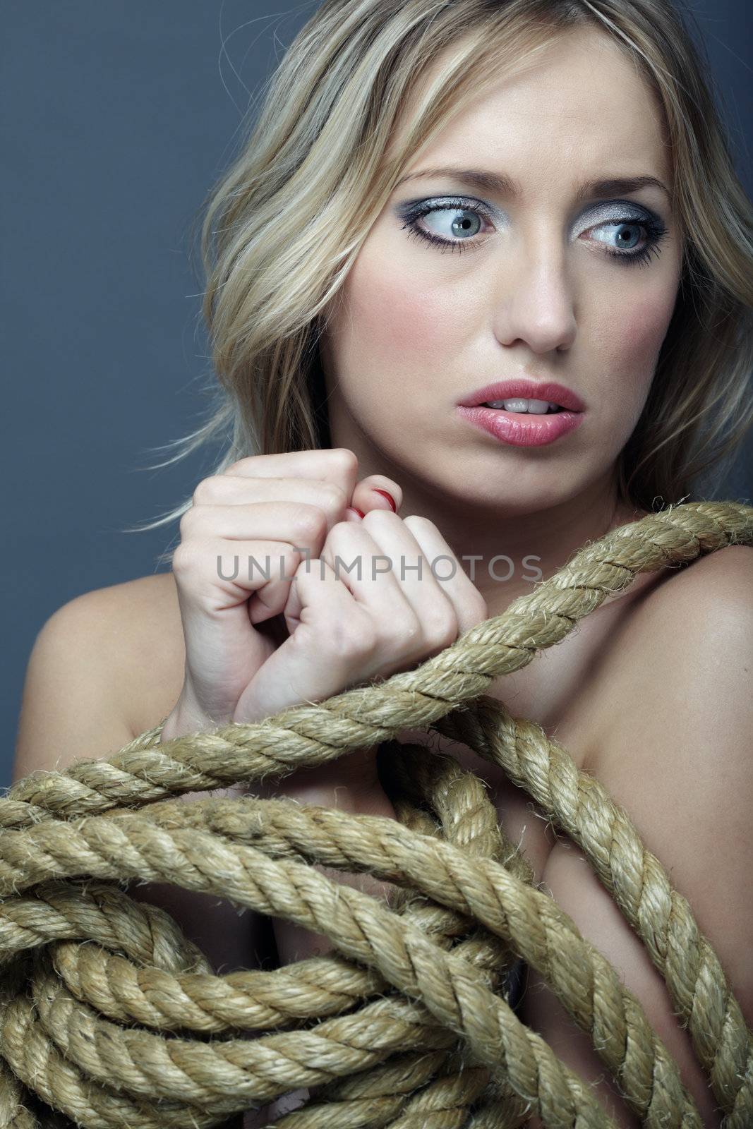 Suffering woman with hands tied by terrible rope