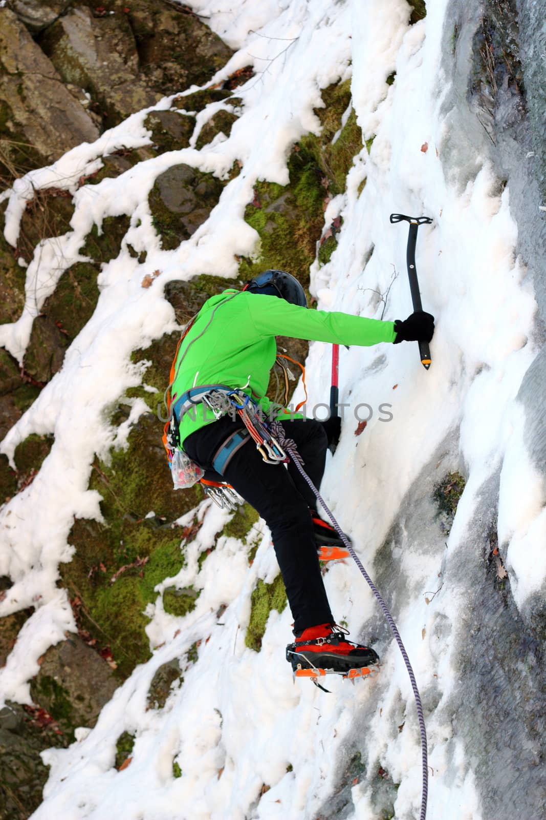 mountaineer on ice wall by taviphoto