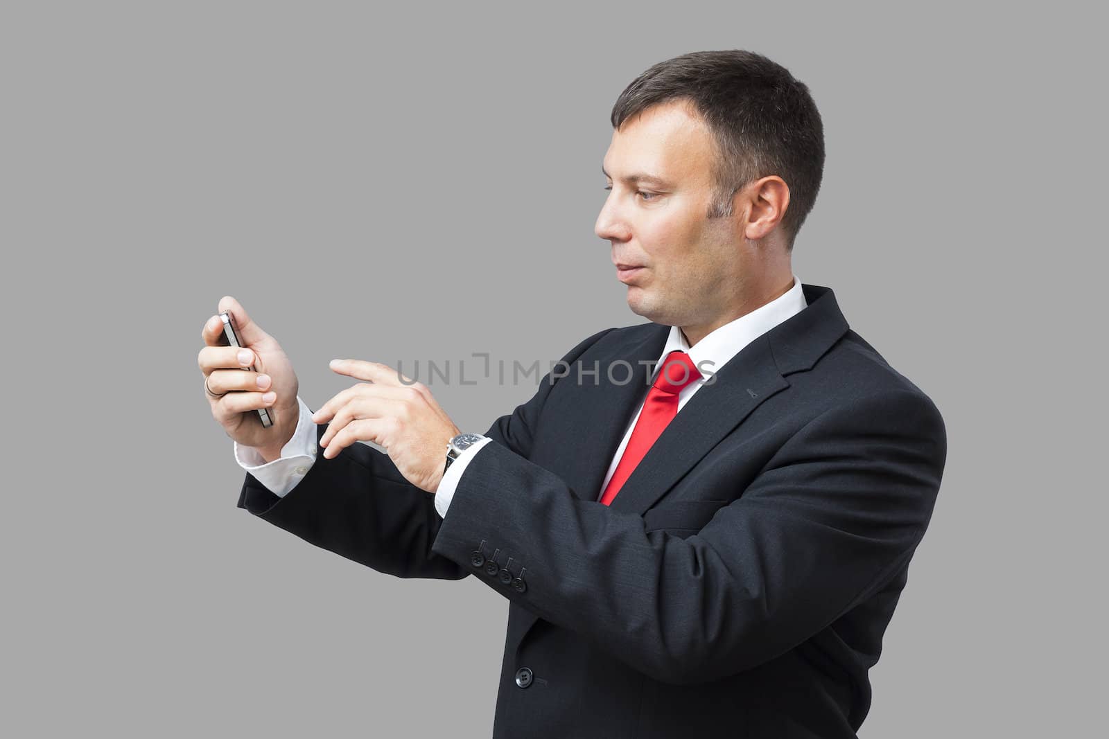 An image of a handsome business man and his mobile phone