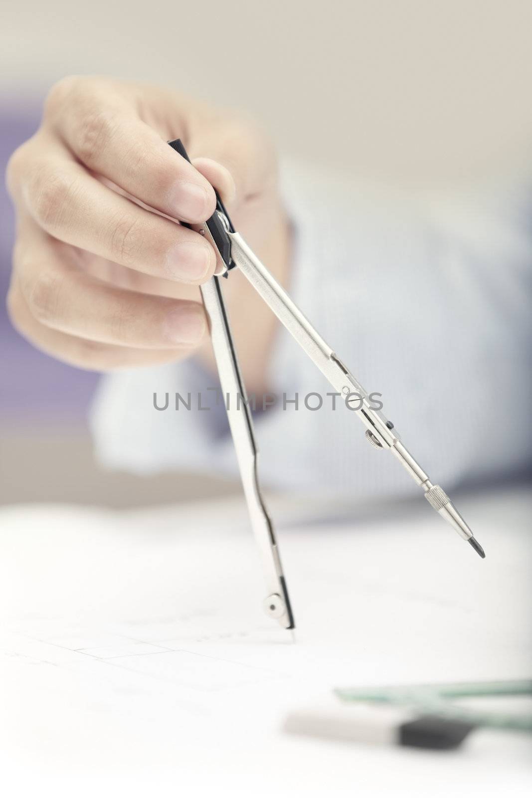 Hand of engineer working with compasses