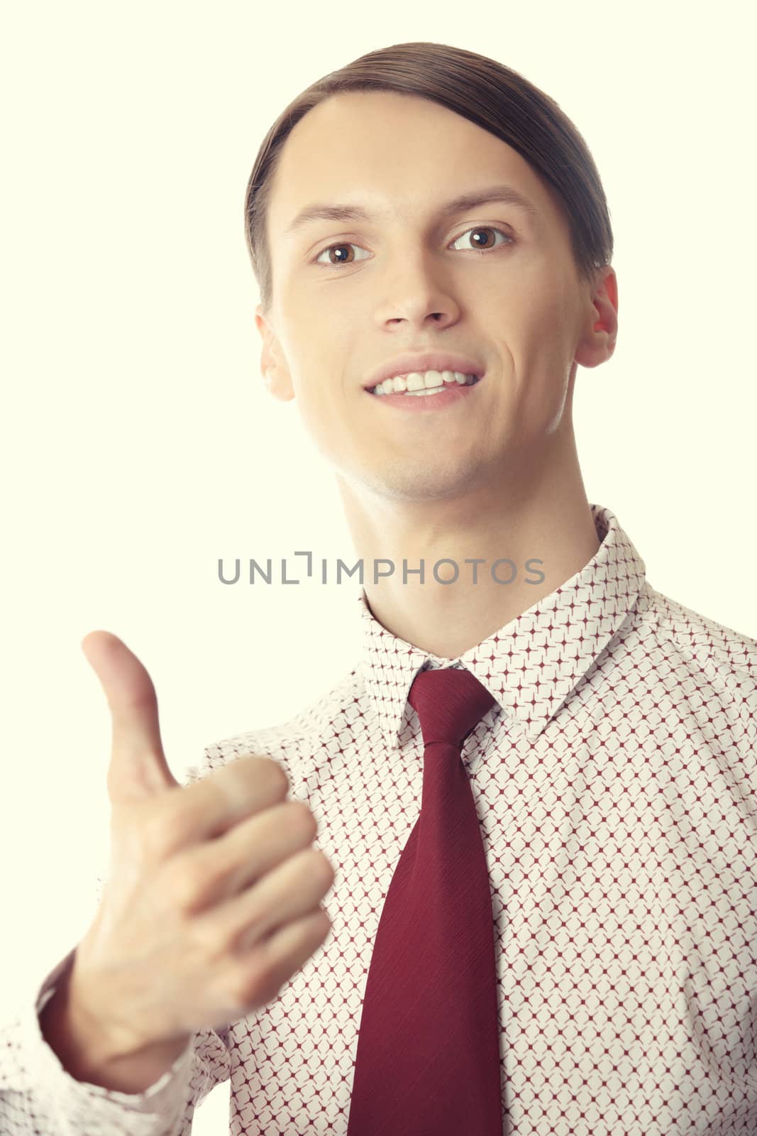 Successful businessman making thumbs up gesture