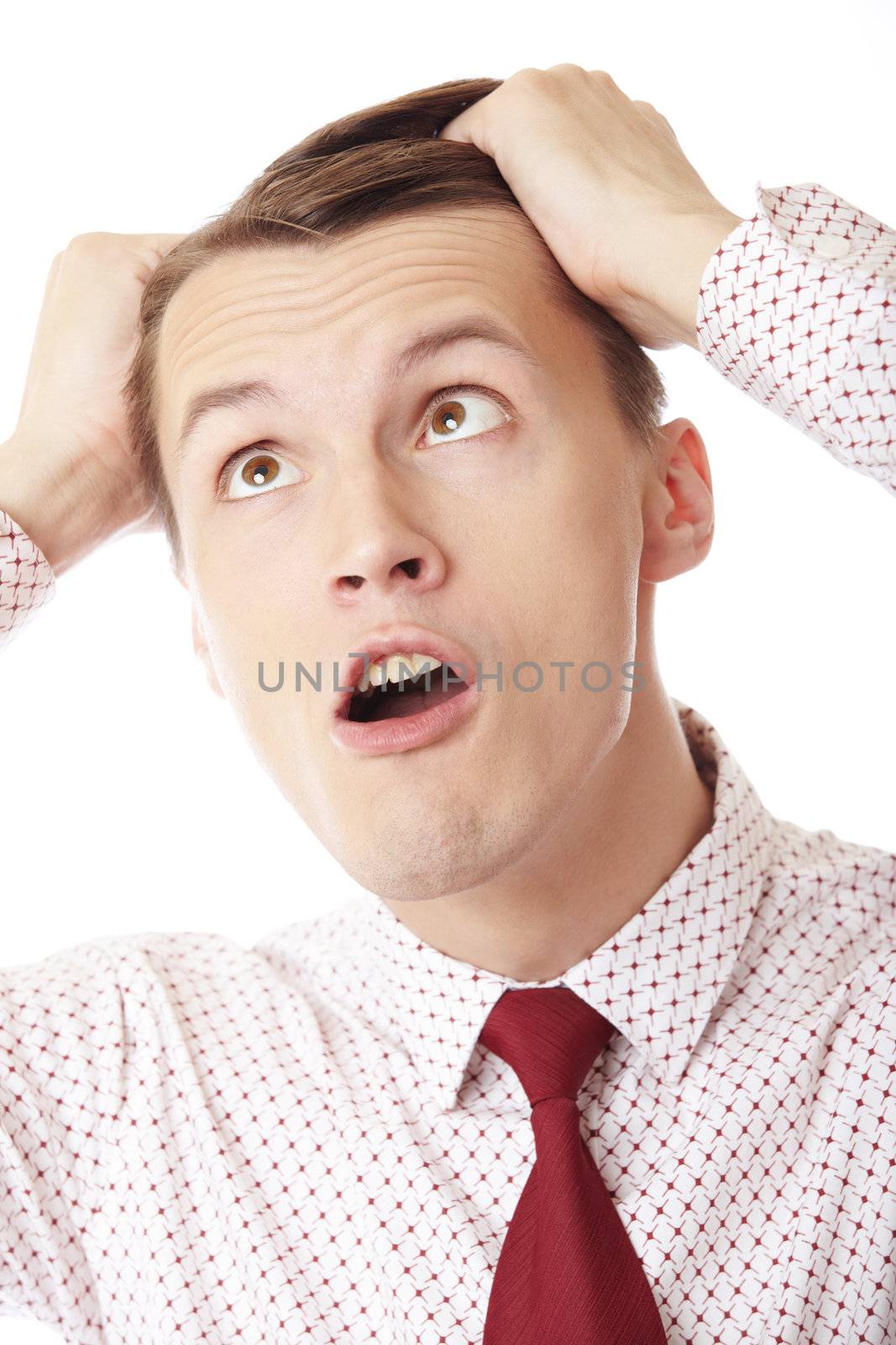 A businessman in trouble screaming on white background