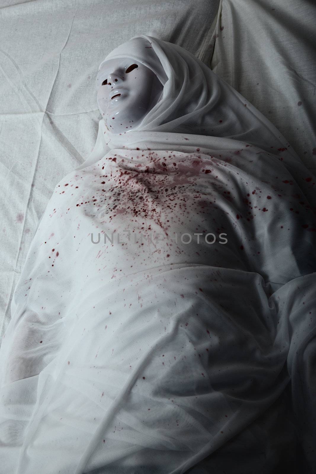 Mummy with mask and bloody spot. Artistic darkness and colors added