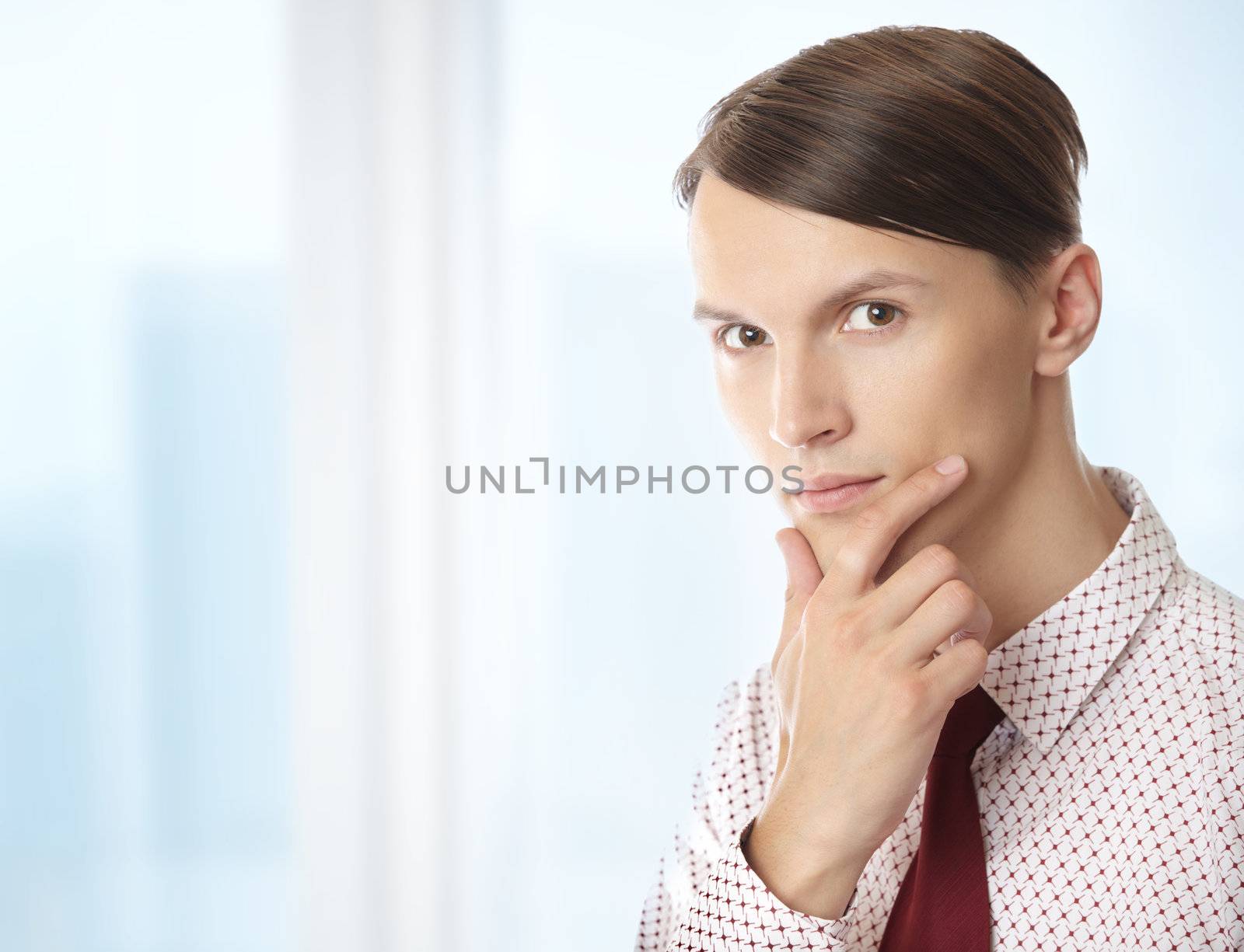 Businessman in formal wear thinking in his office