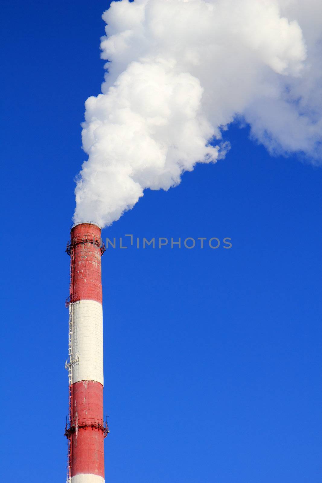 Smoking pipes of thermal power plant against blue sky