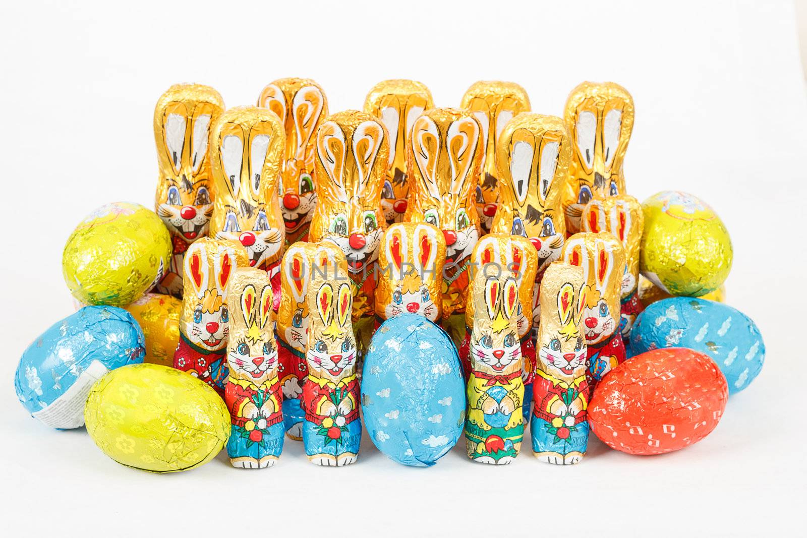 group of many color easter chocolate rabbits bunny and eggs on white background