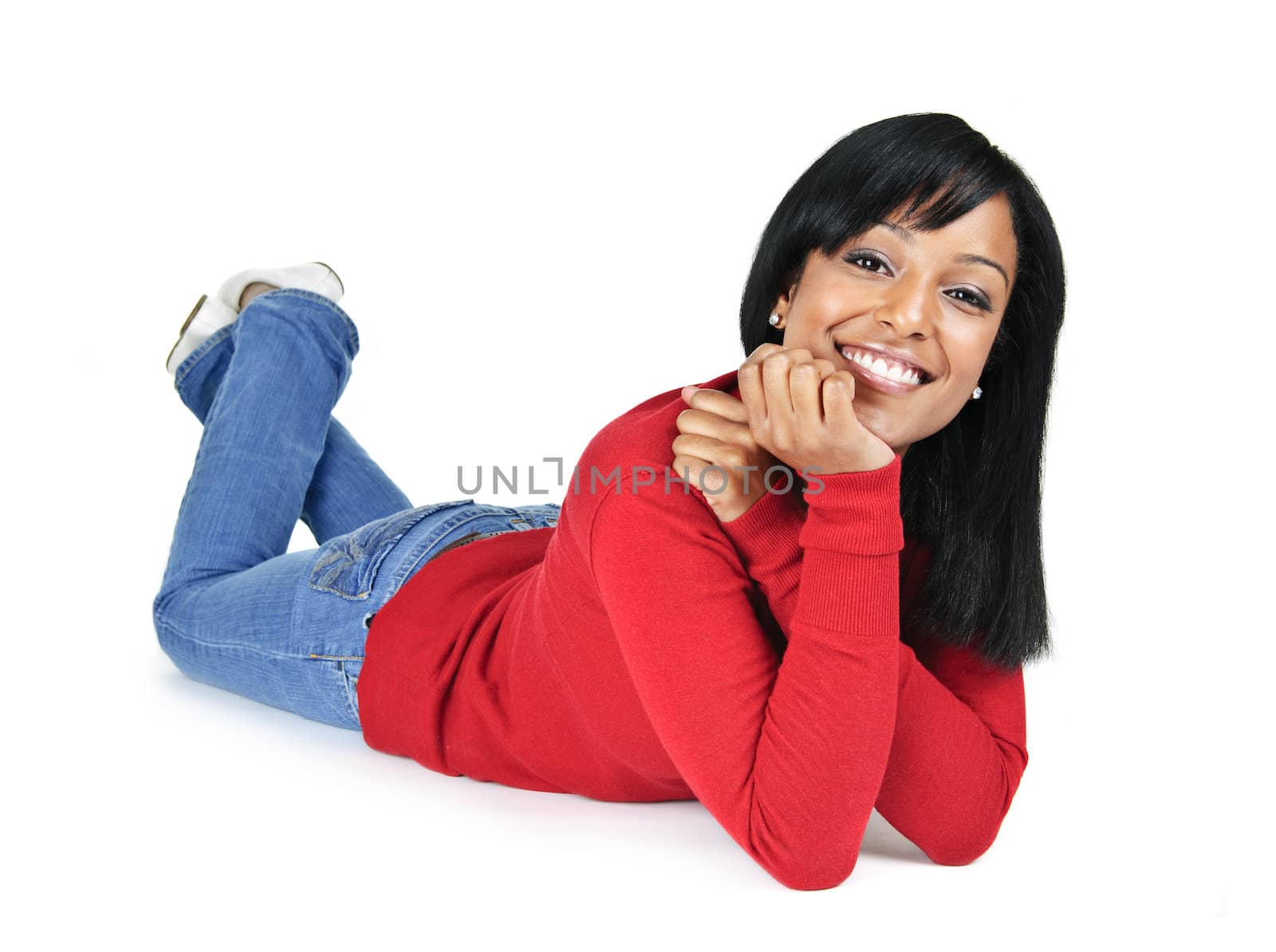 Smiling young woman relaxing laying down by elenathewise