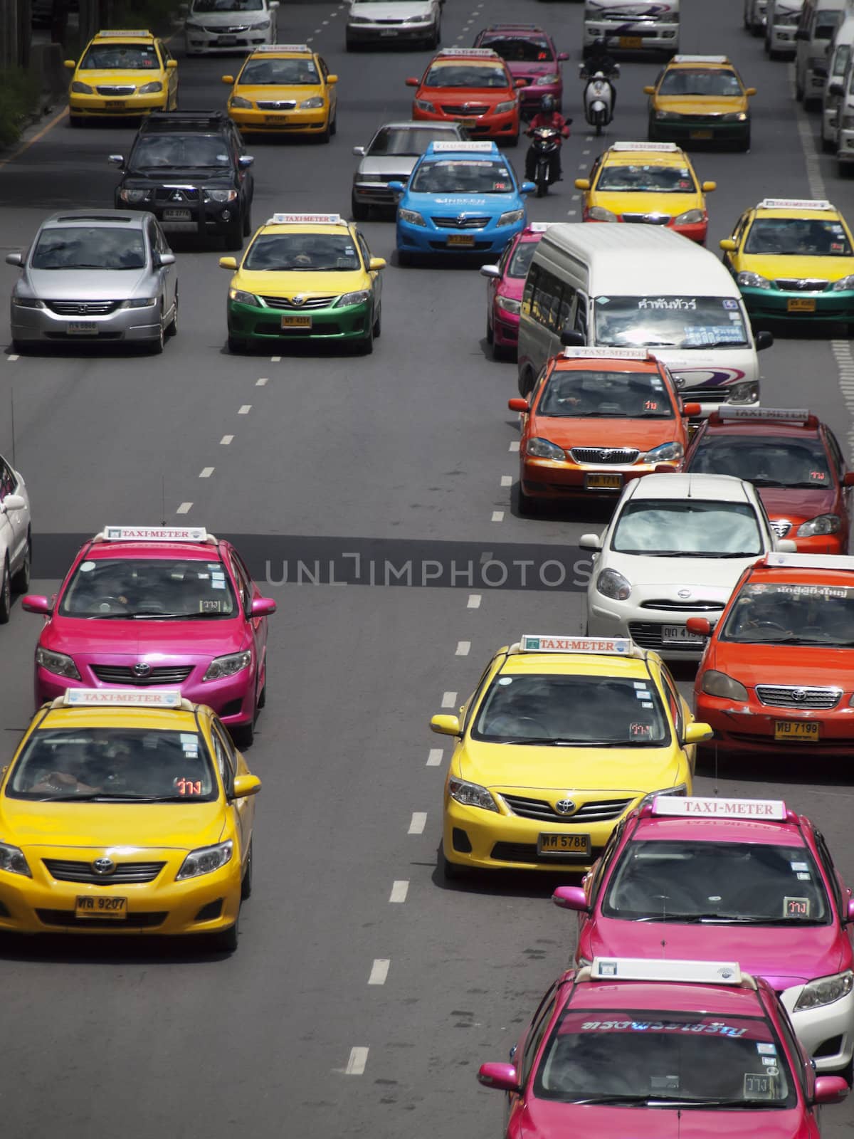 14 July 2012: Bangkok, Thailand. Colorful taxis driving in the city of Bangkok in Thailand