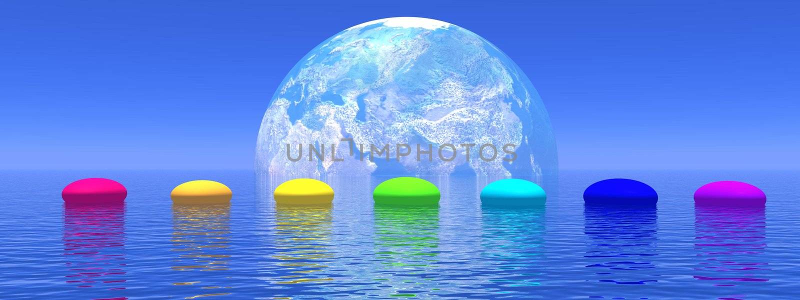 Line of seven pebbles with chakras colors upon the deep blue ocean, in front of earth shadow, horizon in the background