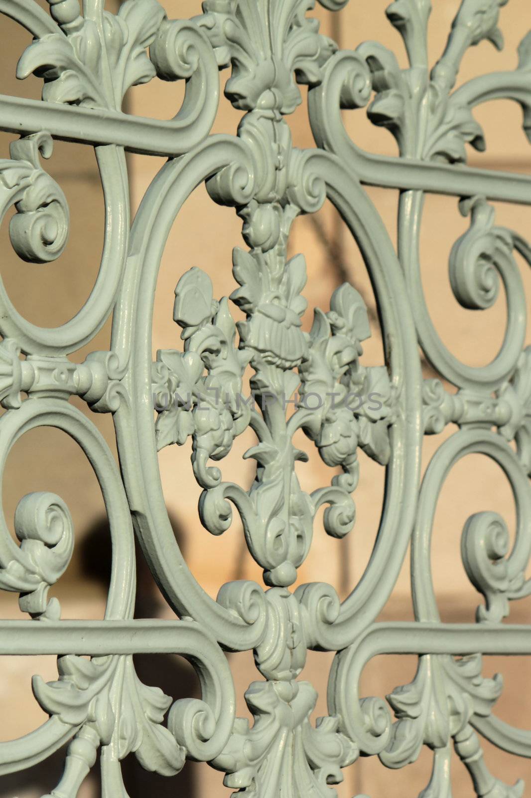 Close up on a detail of a vintage grey metallic fence in a park