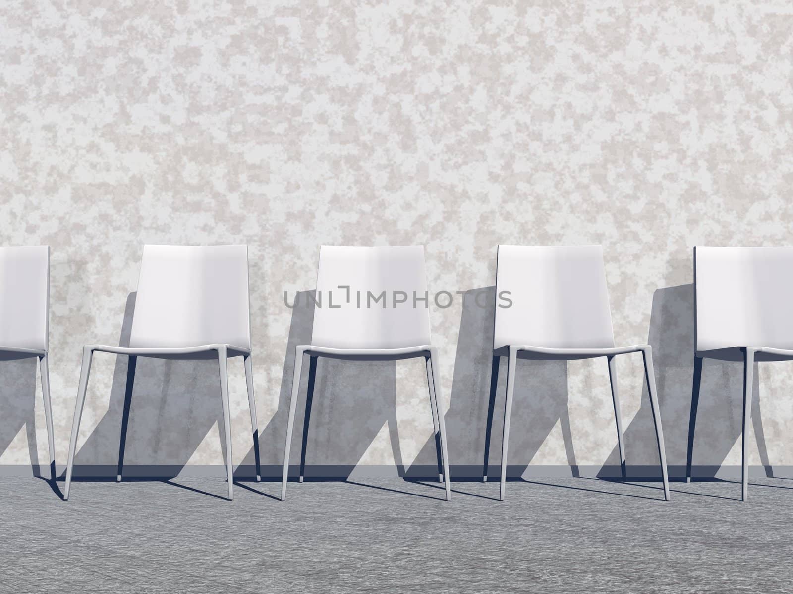 Several white chairs against the wall in a waiting room