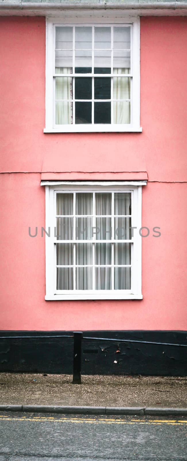 A pink house with white windows in Suffolk, England