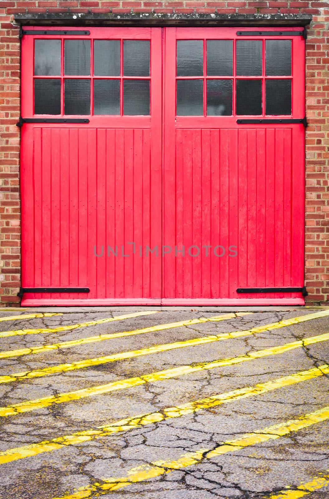 Red fire station door with yellow lines