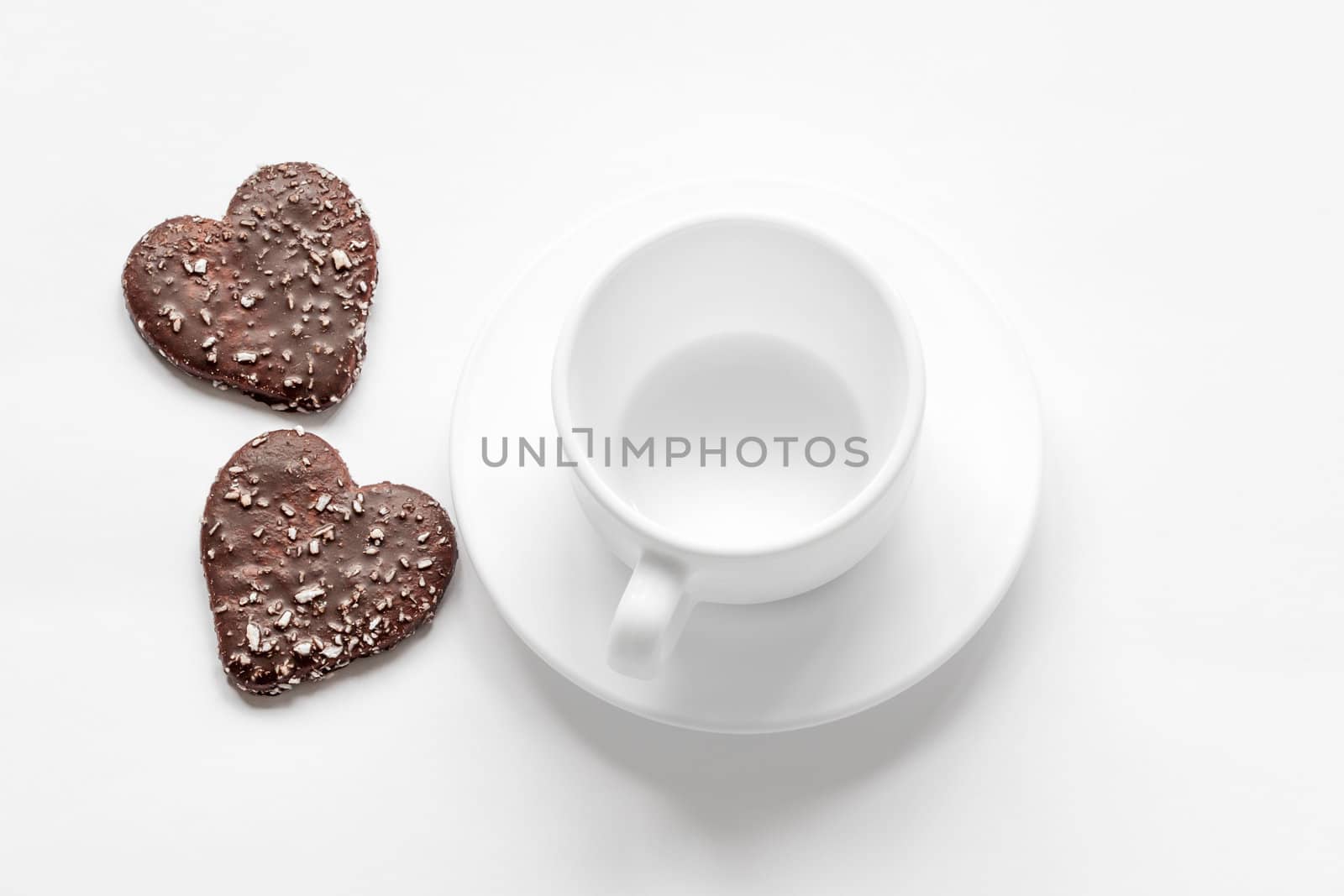 cup and saucer and a chocolate coconut cookies
