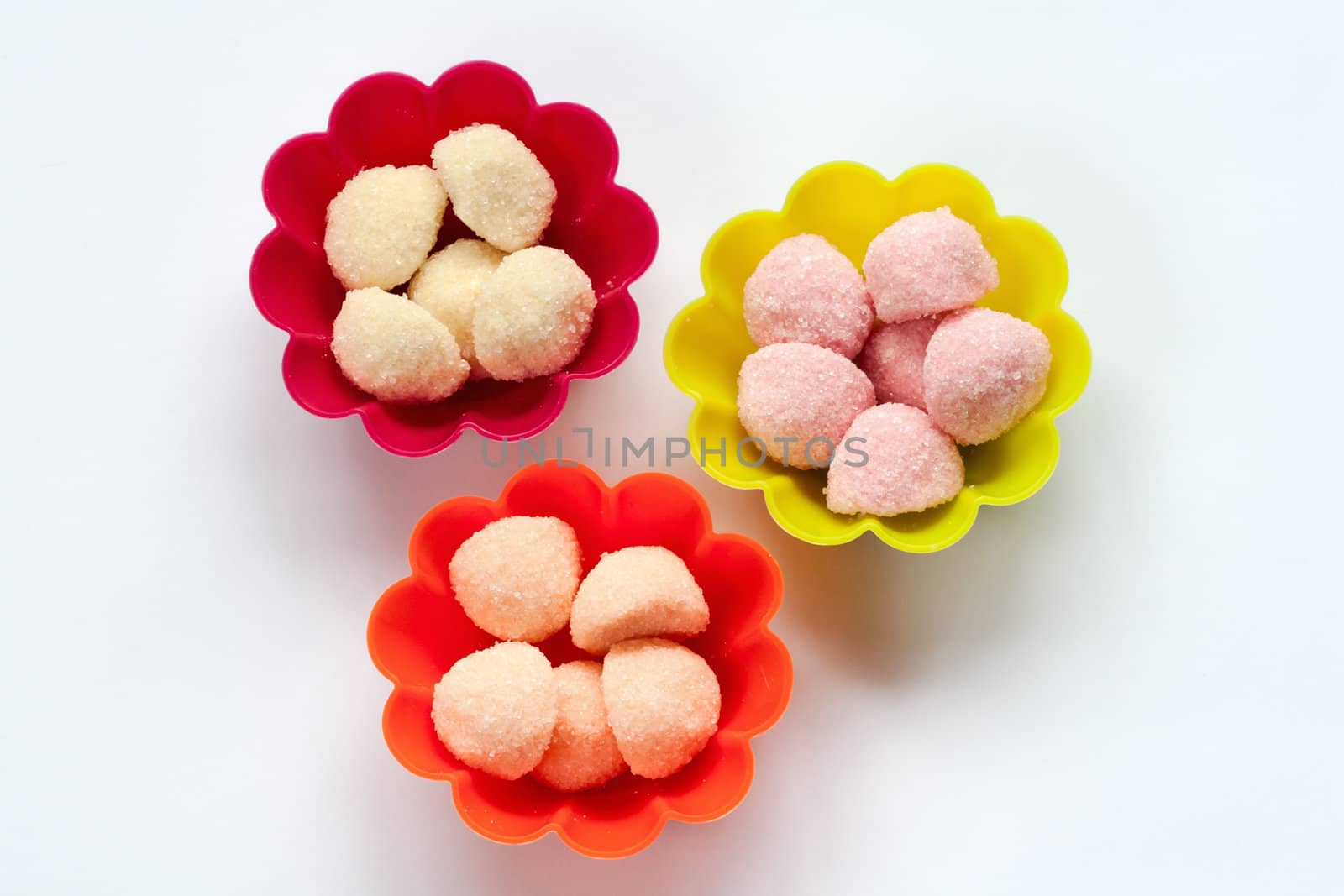 sweet jelly candies in cup cake cases on white