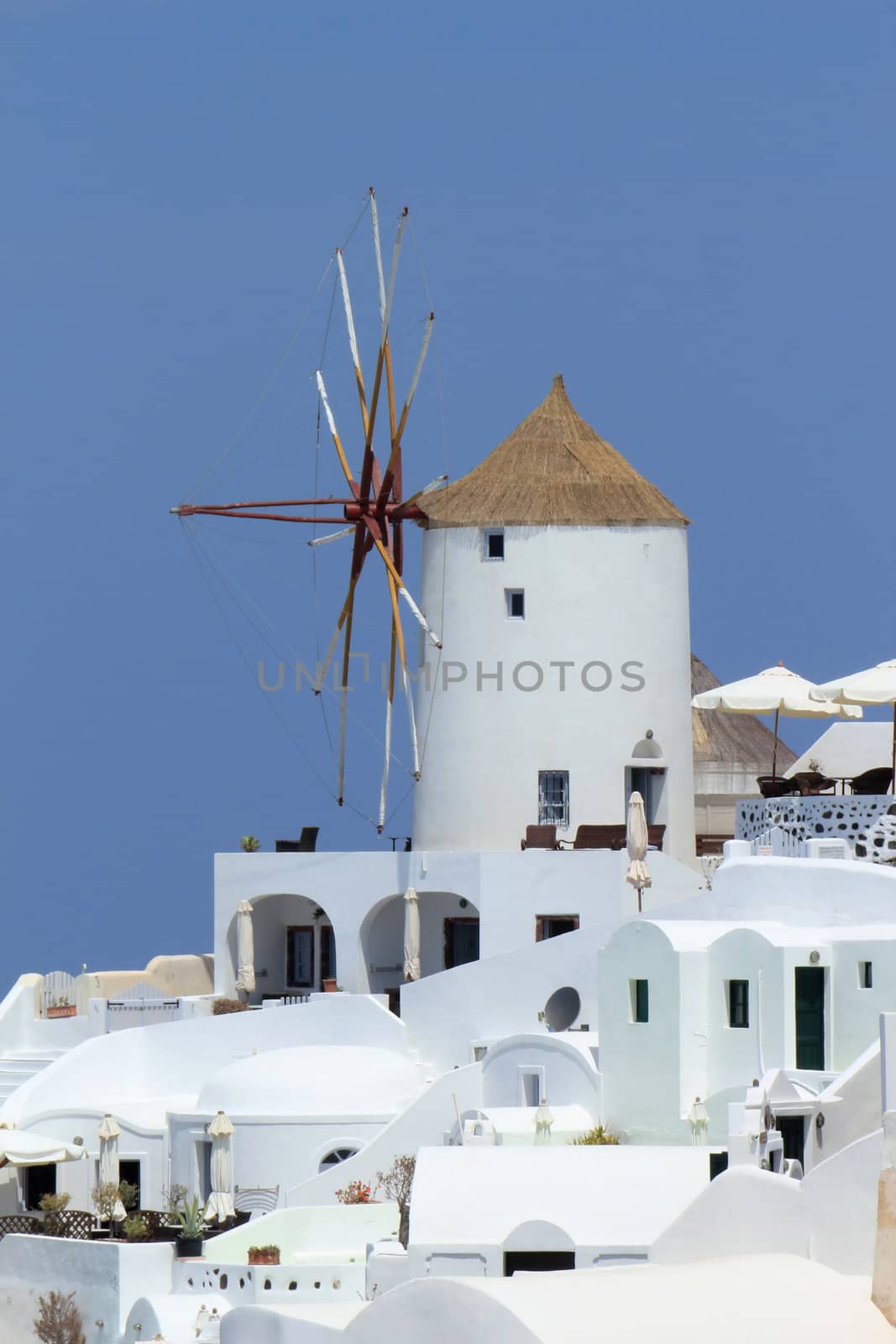 White old windmill at Oia village on the island of Santorini, cyclades, Greece