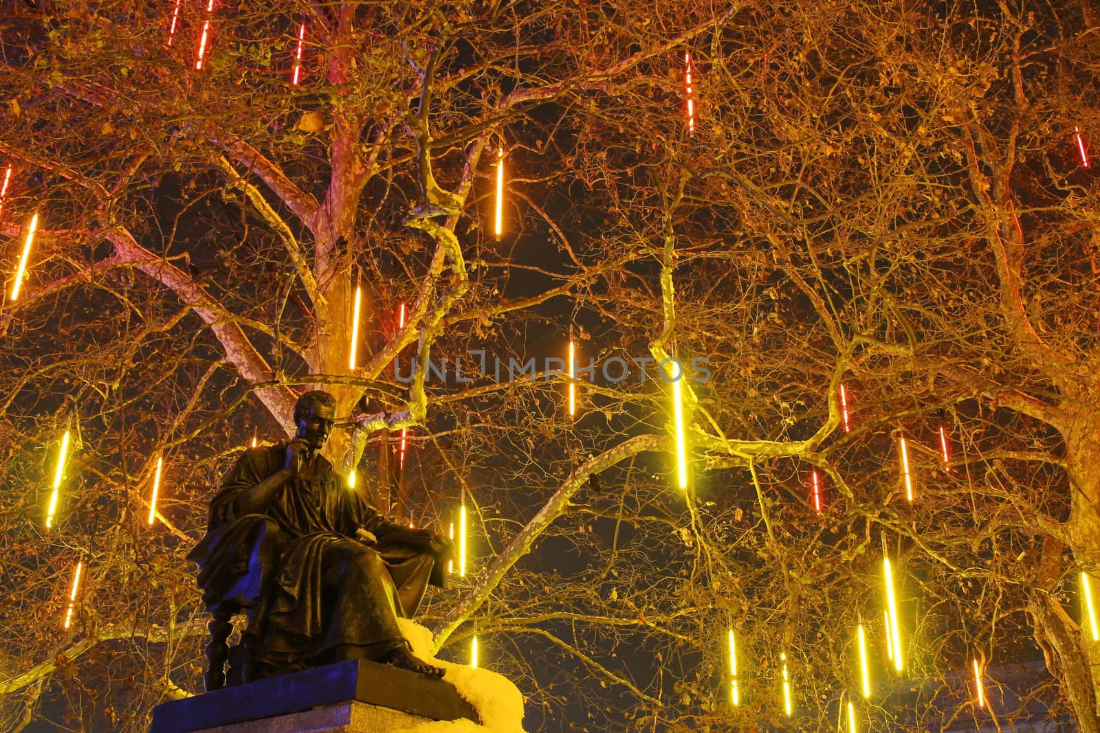 GENEVA, SWITZERLAND - DECEMBER 2 : festival of lights on a tree in front of Jean-Jacques Rousseau statue, on December 2, 2010, in Geneva, Switzerland.