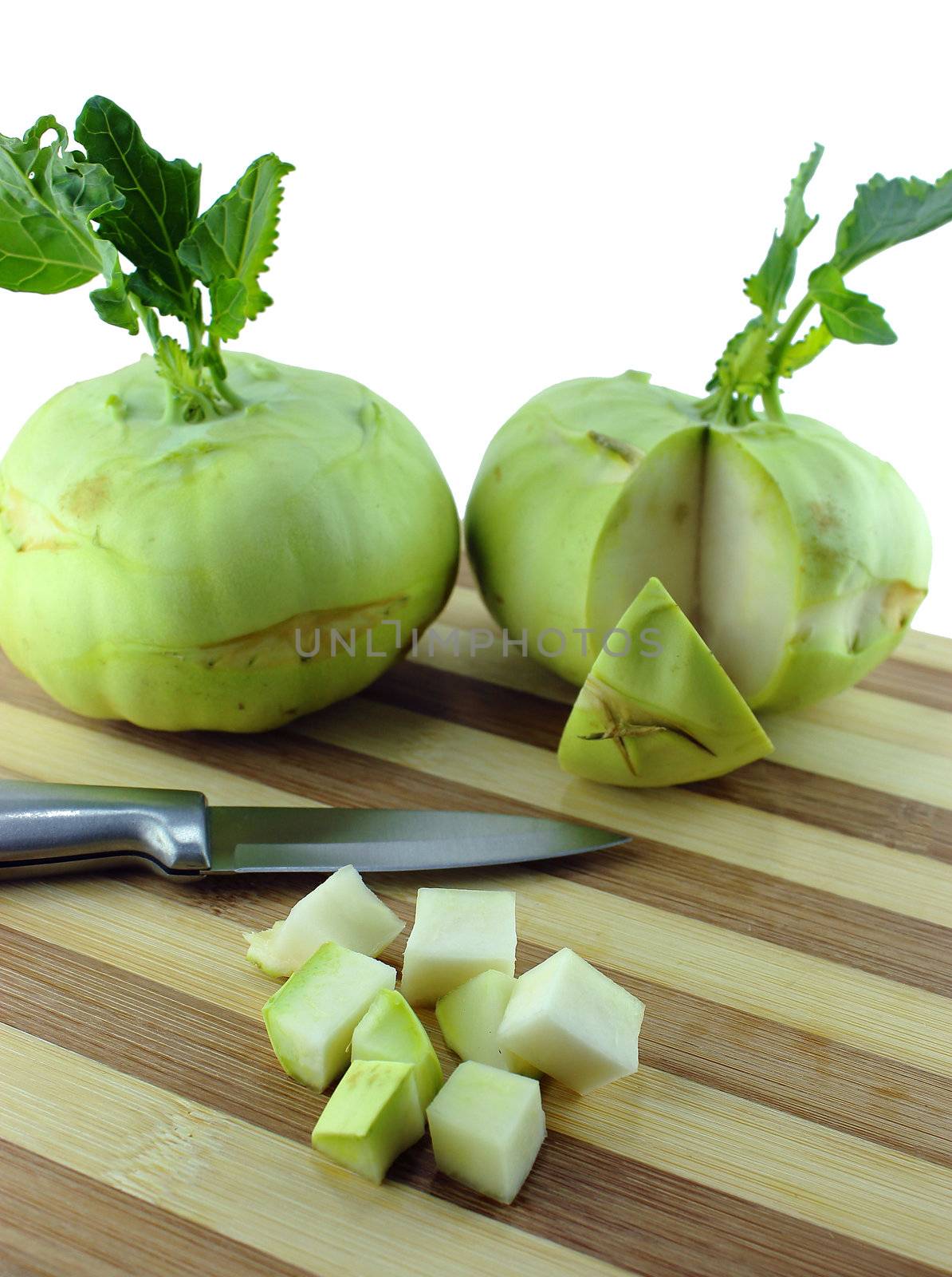 Cabbage kohlrabi on Wooden Kitchen Board with knife.