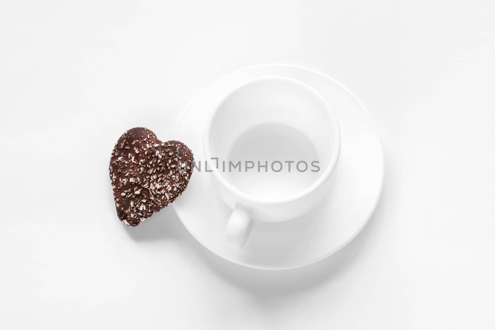 cup and saucer and a chocolate coconut cookies