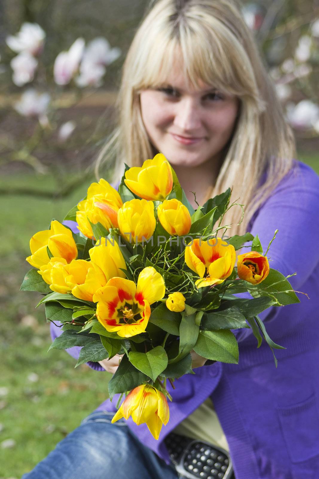 Happy woman holding flowers by miradrozdowski