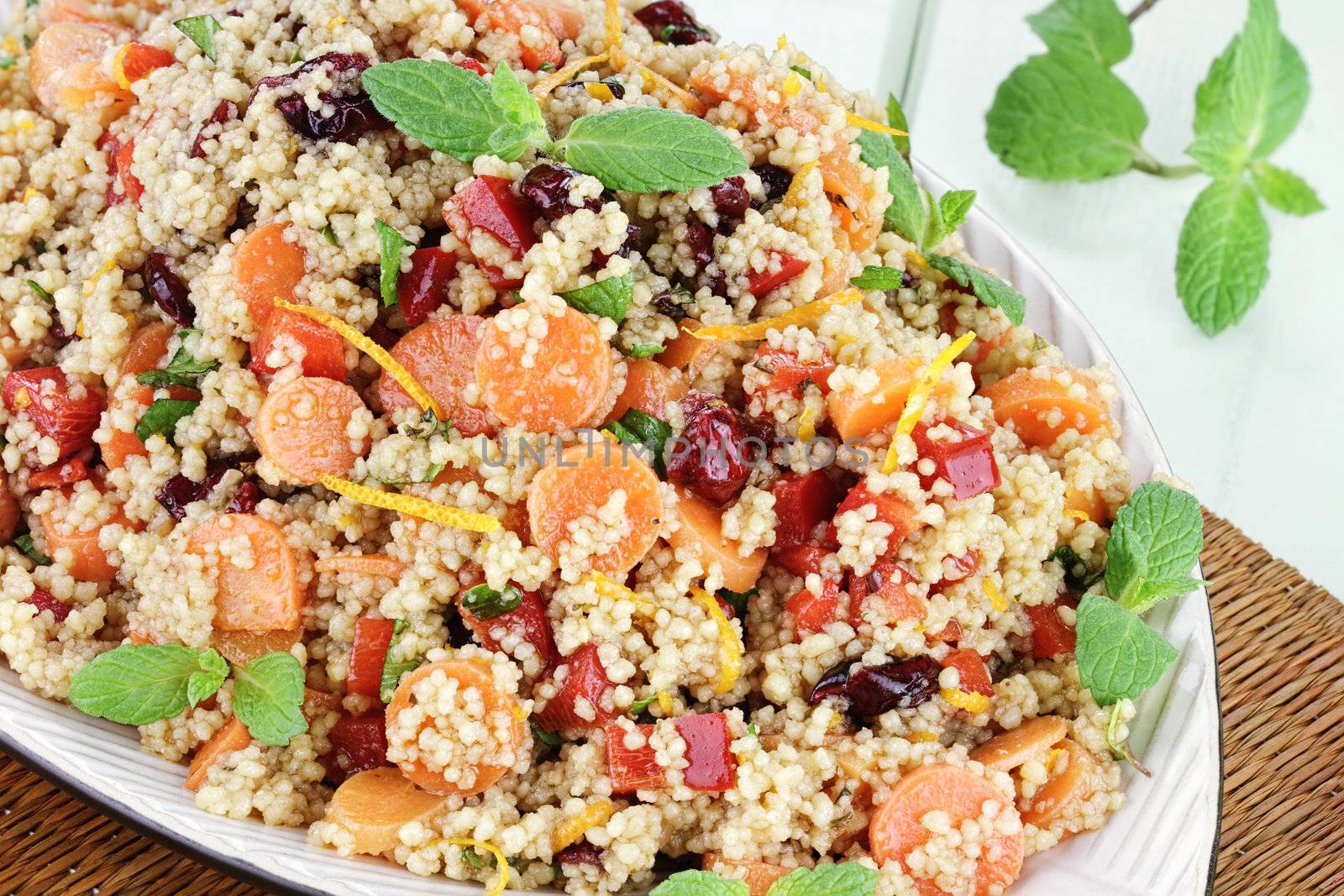 Citrus Couscous Salad with orange zest, carrots,  red bell pepper, dried cranberries and fresh mint. 

