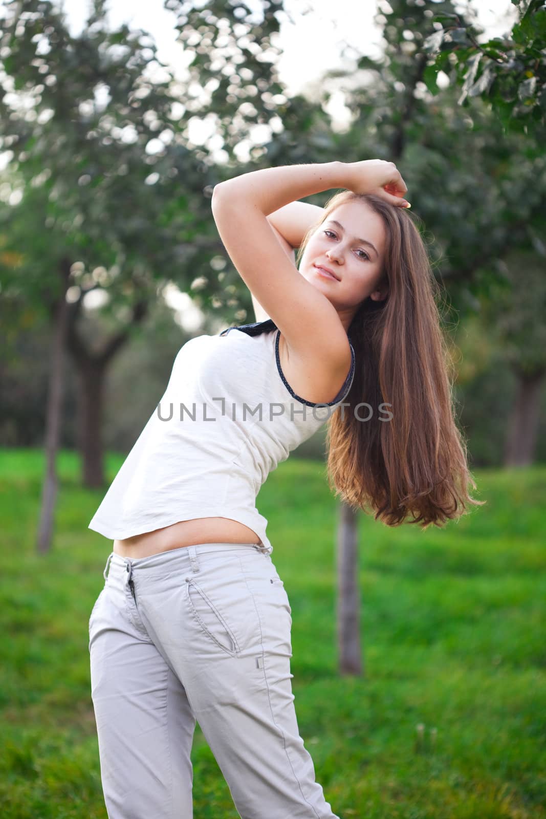 beautiful young woman standing on green grass
