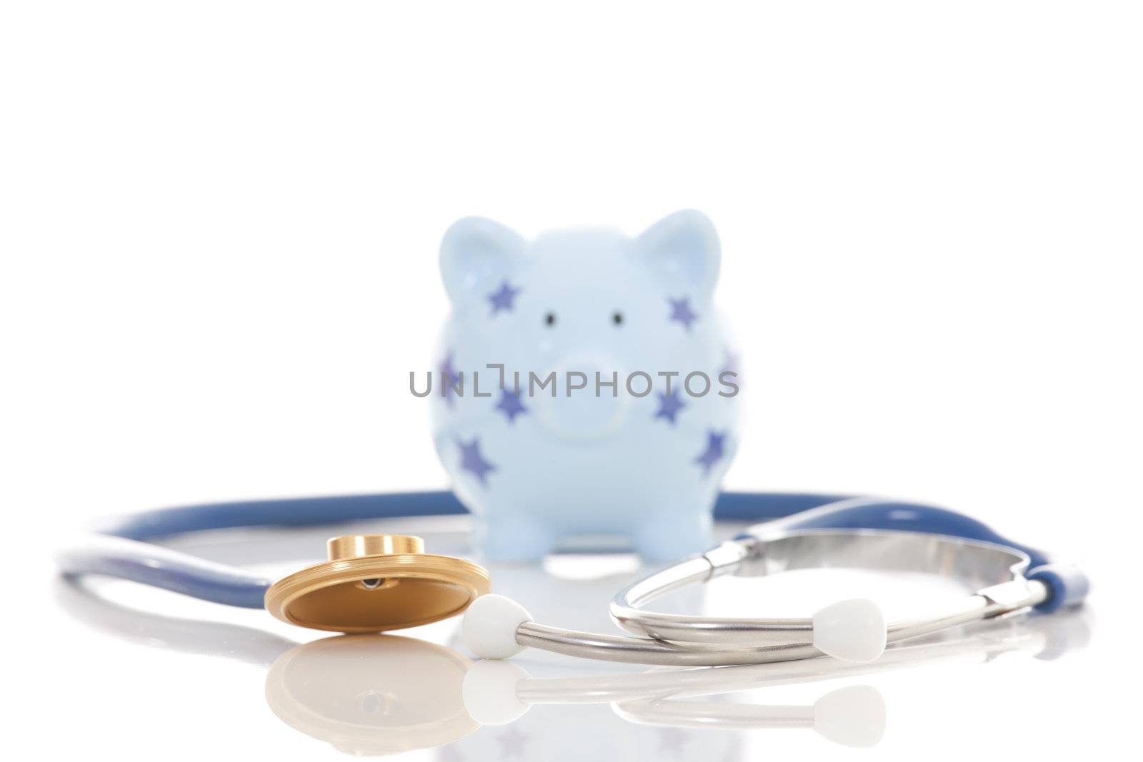 Piggy bank and stethoscope isolated on white