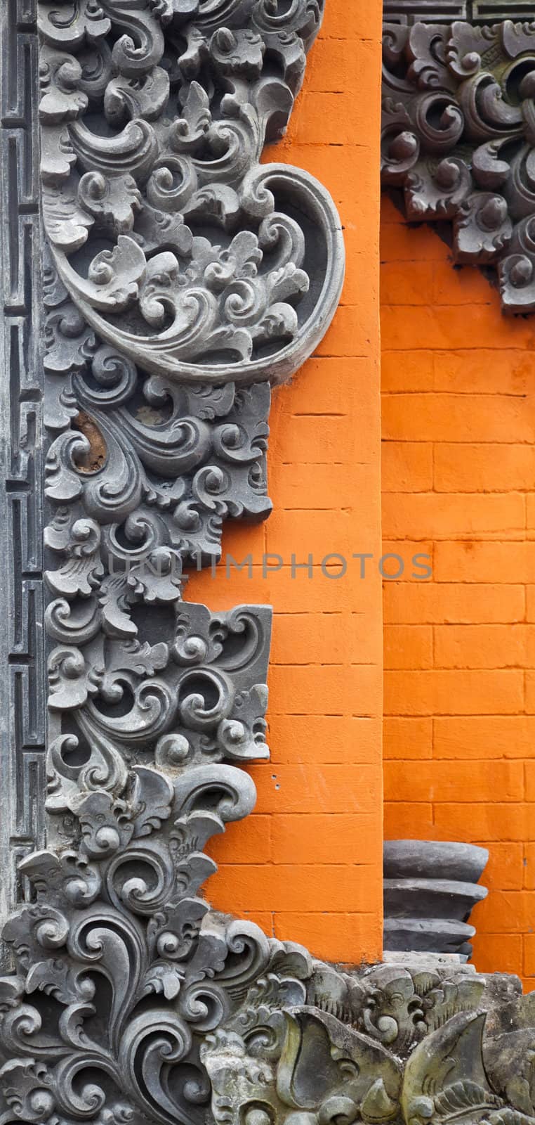 Bali brick wall with stone carving