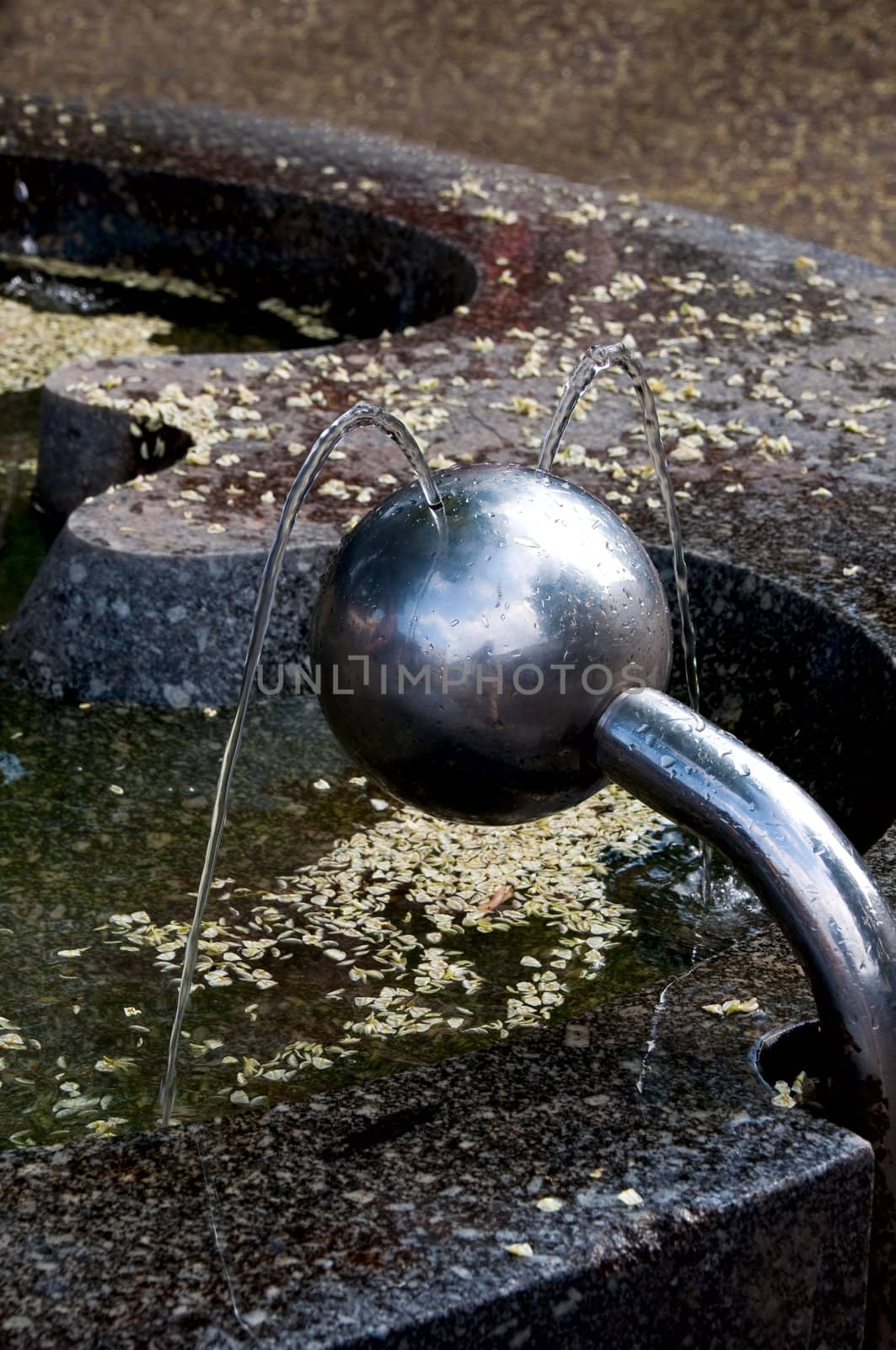 Drinking fountain in the form of a ball beating in two streams  