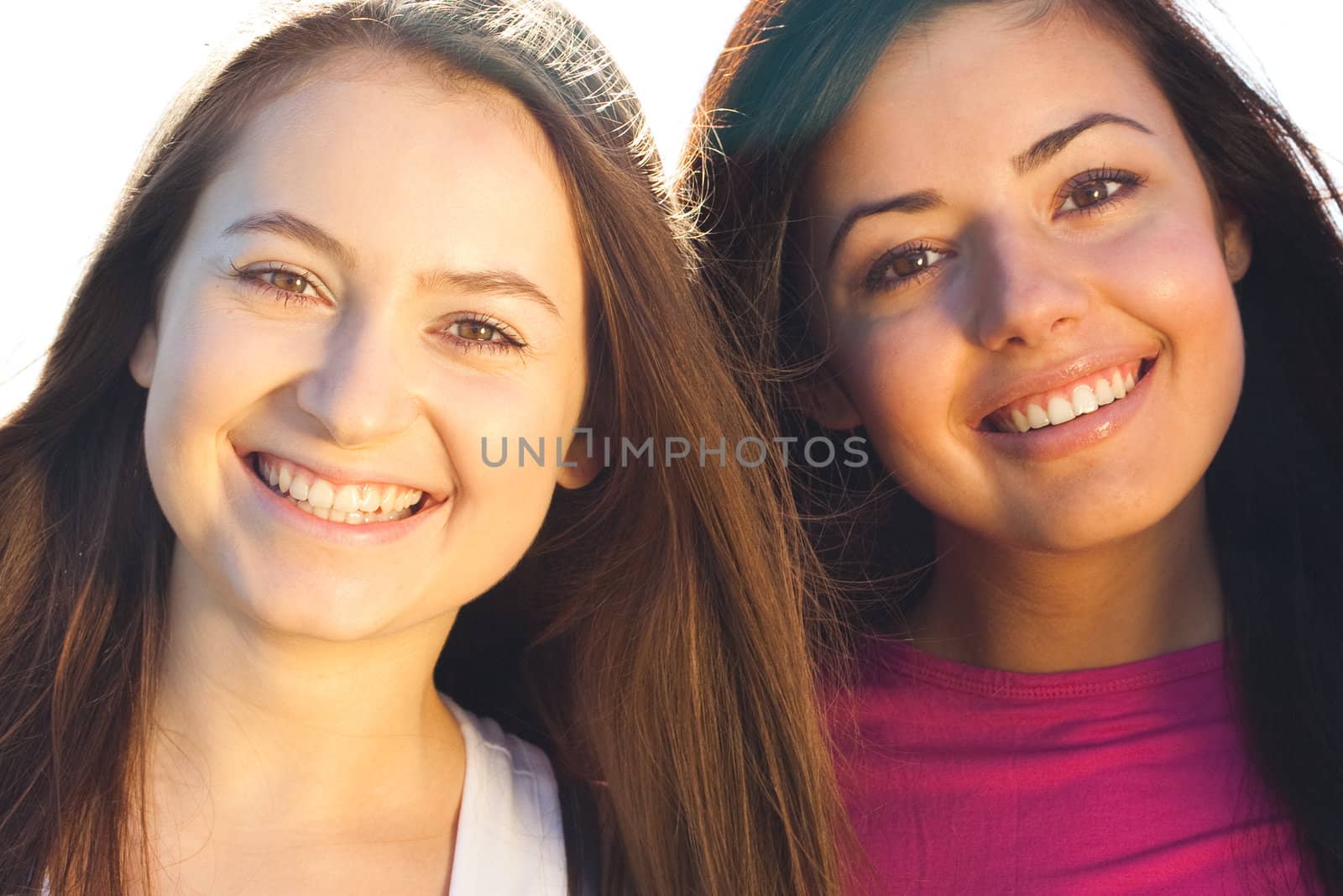 portret of two young beautiful woman on the  sky background 