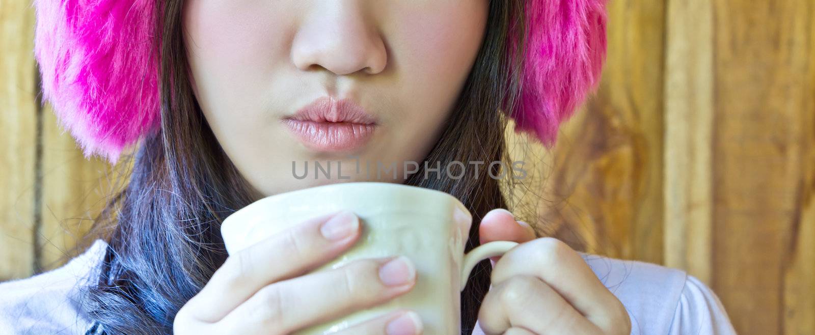 Asian woman drinking coffee by Myimagine