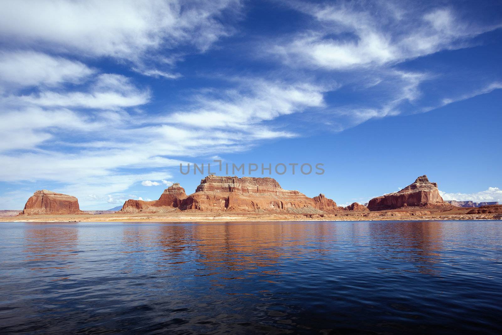 famous red cliffs reflected in the smooth water of the lake Powell