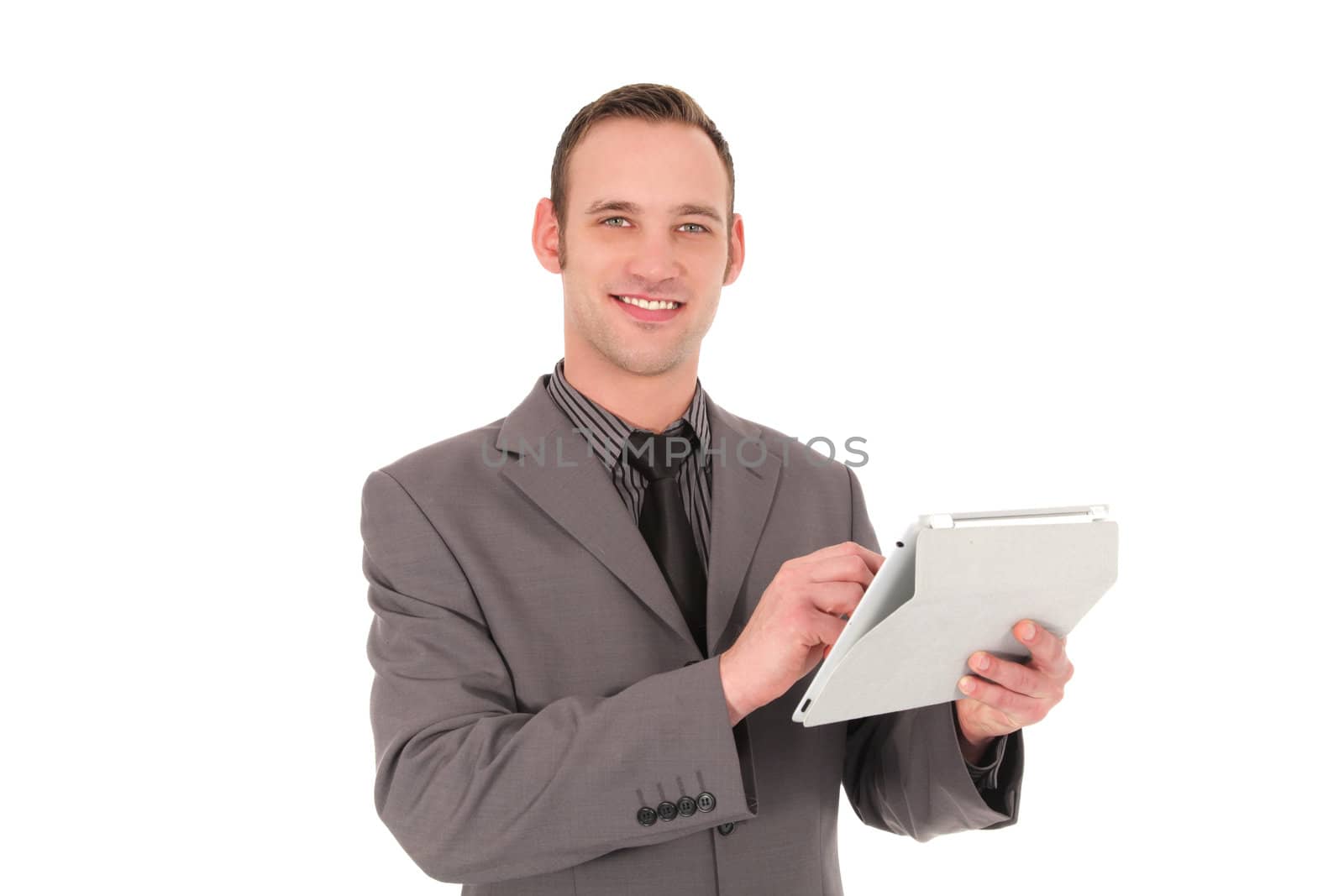 Smiling businessman working on his tablet isolated on white