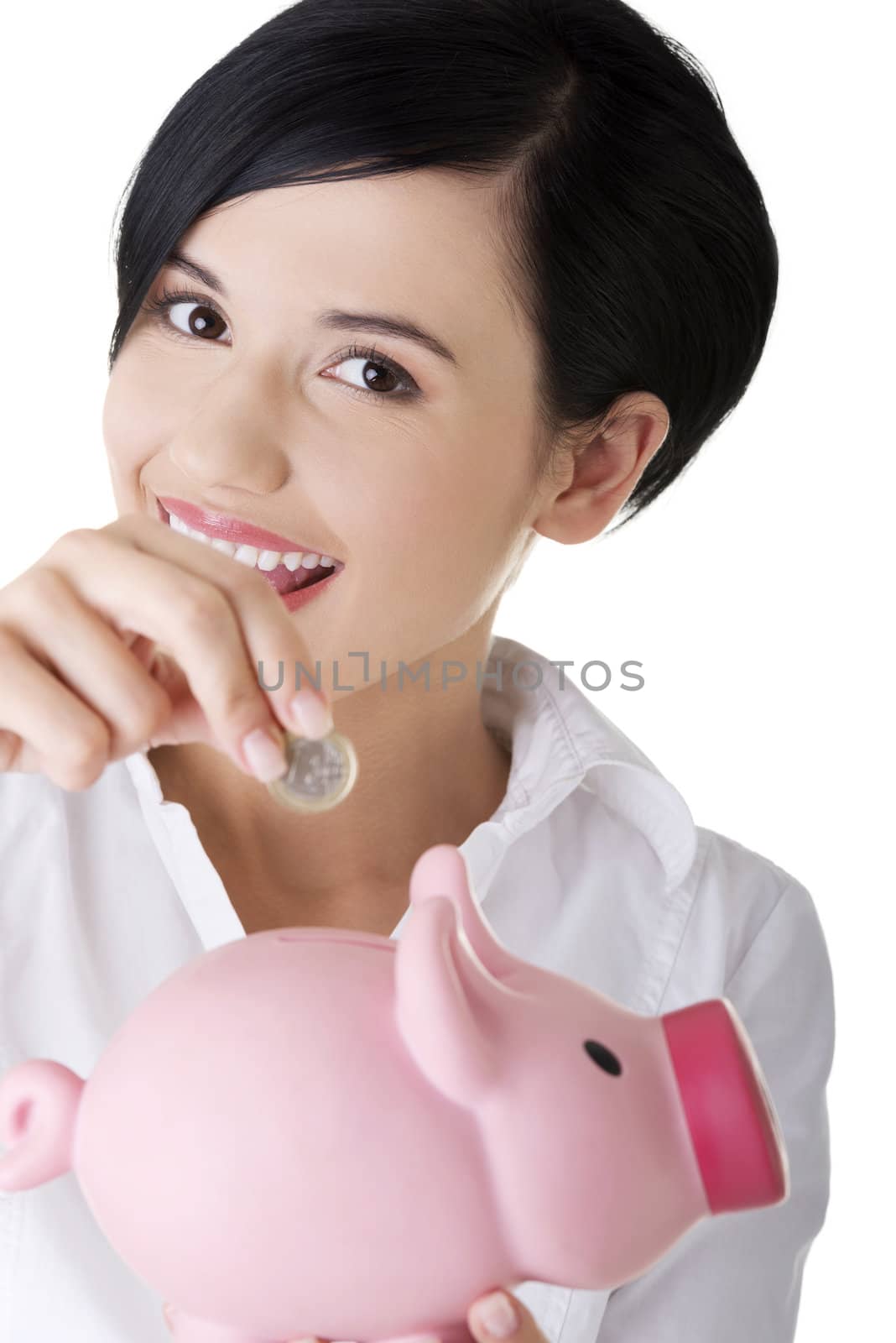 Happy business woman with her savings in piggy bank