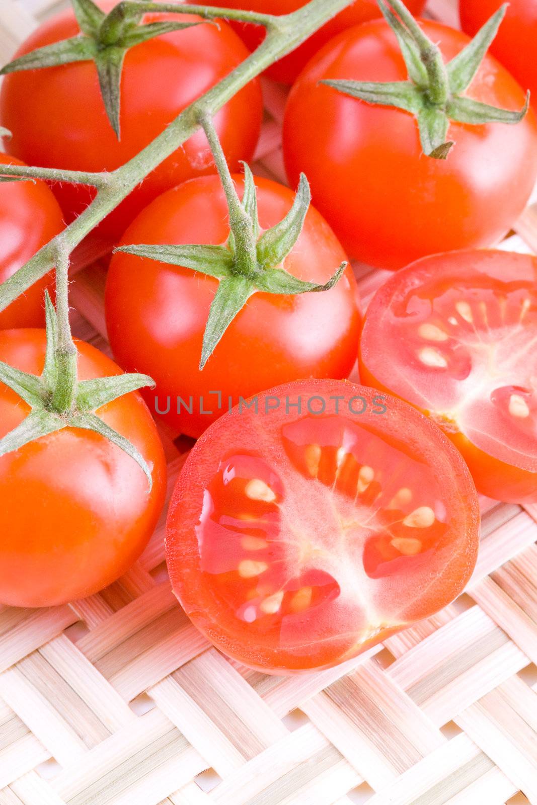 Small cocktail tomatoes on a straw braided mat