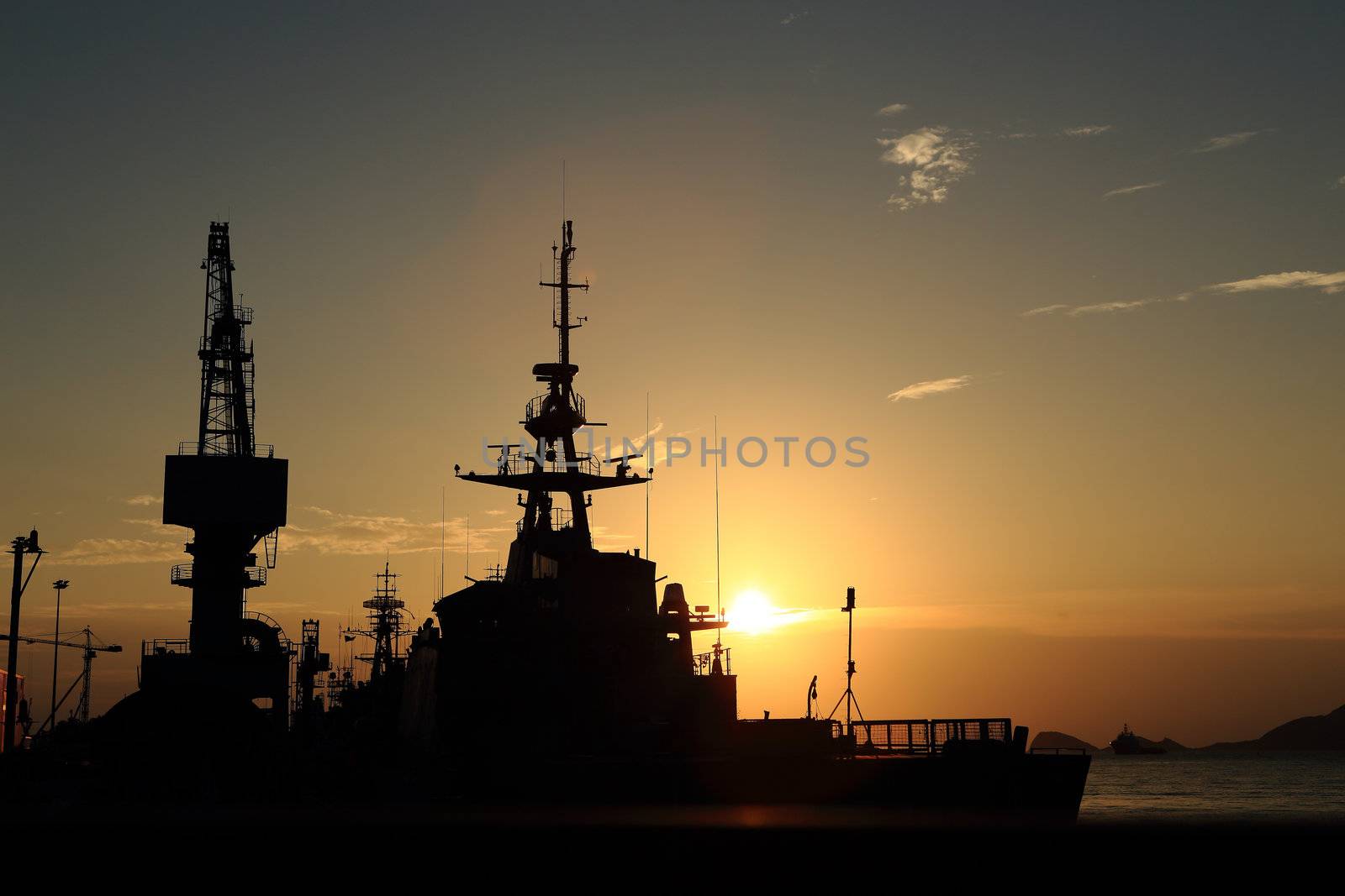 Cranes in dockyard  at sunset