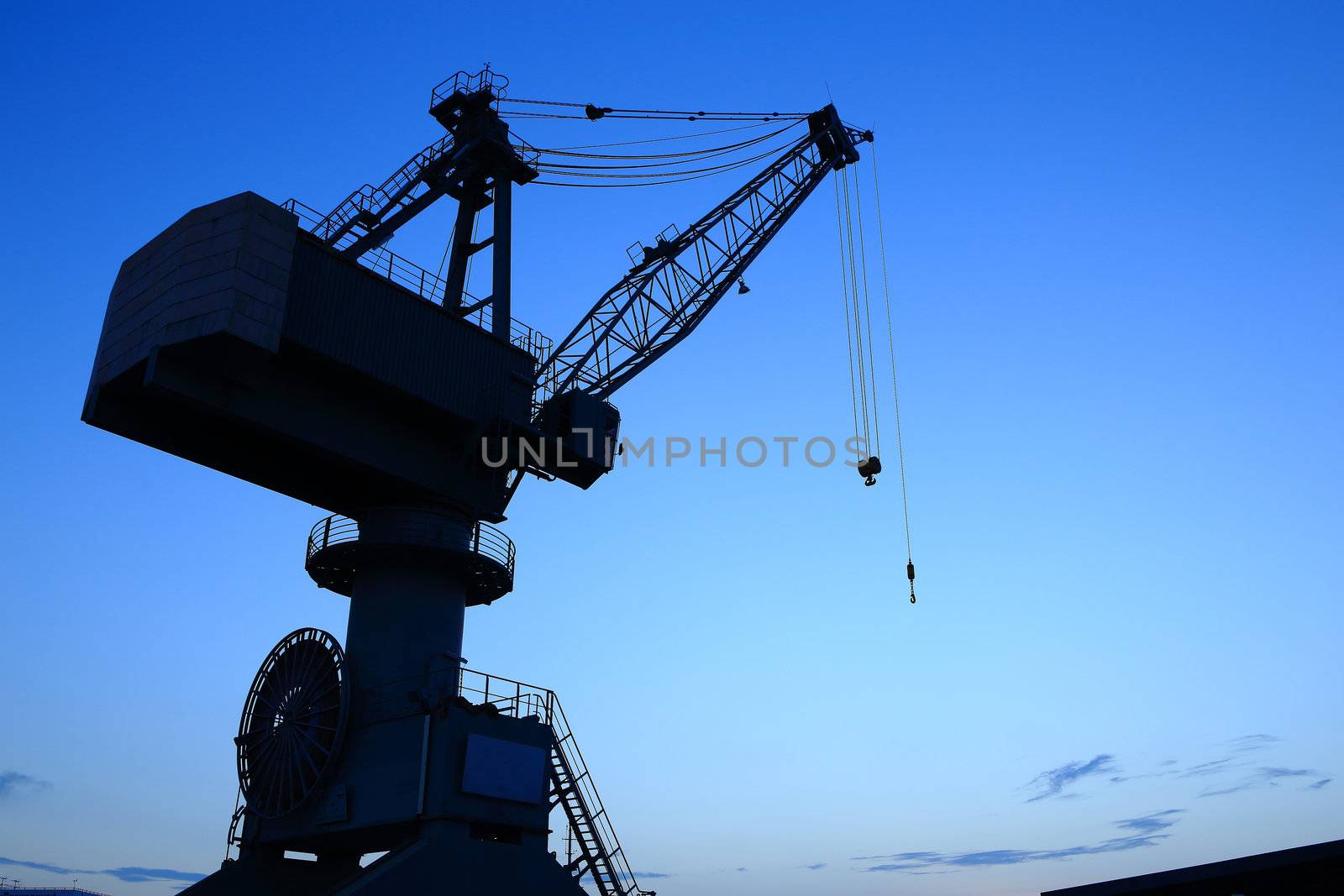 Cranes in dockyard  at sunset