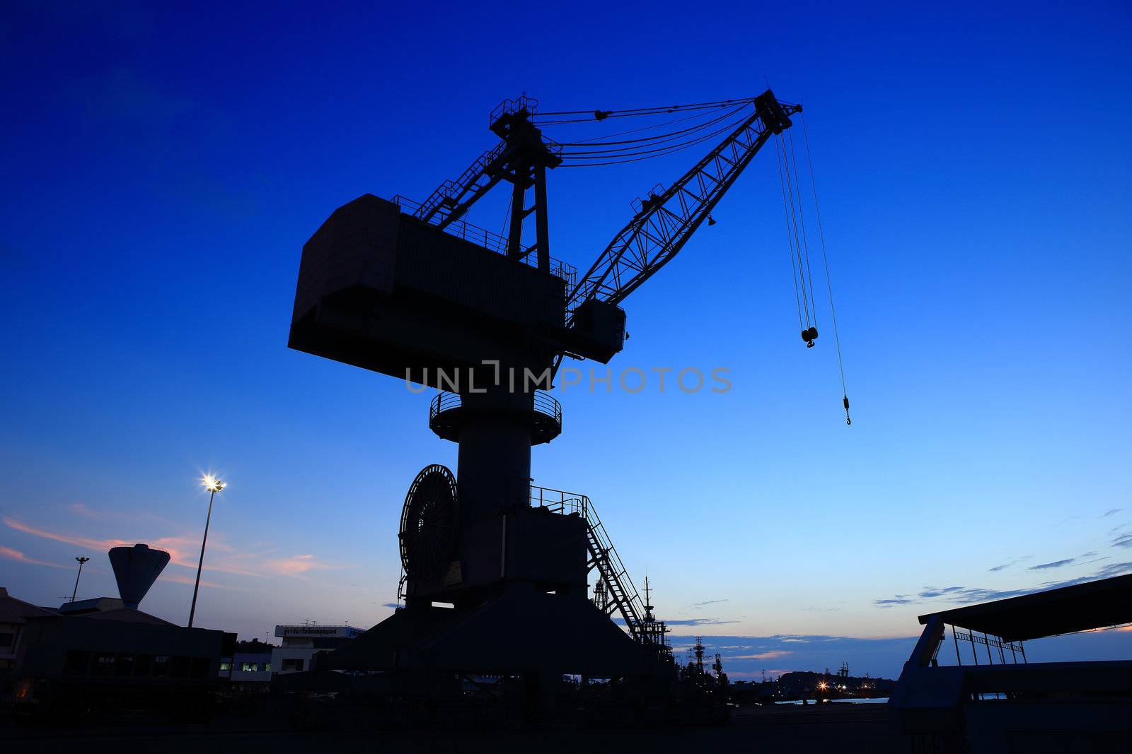 Cranes in dockyard  at sunset