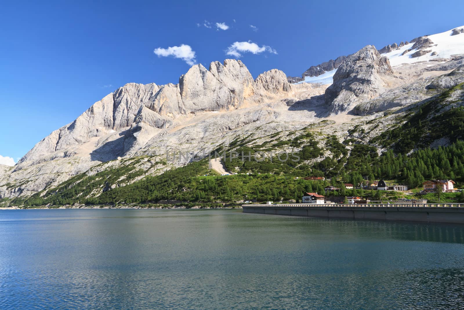 summer view of Fedaia lake beneath Marmolada glacier, Trentino, Italy