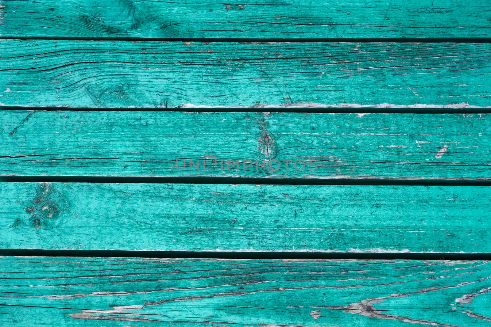 Fragment the shield of parallel horizontal old wooden boards painted in green