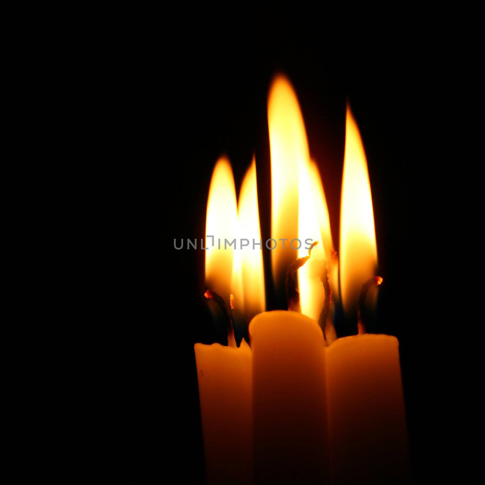 sacred candles in dark on black background