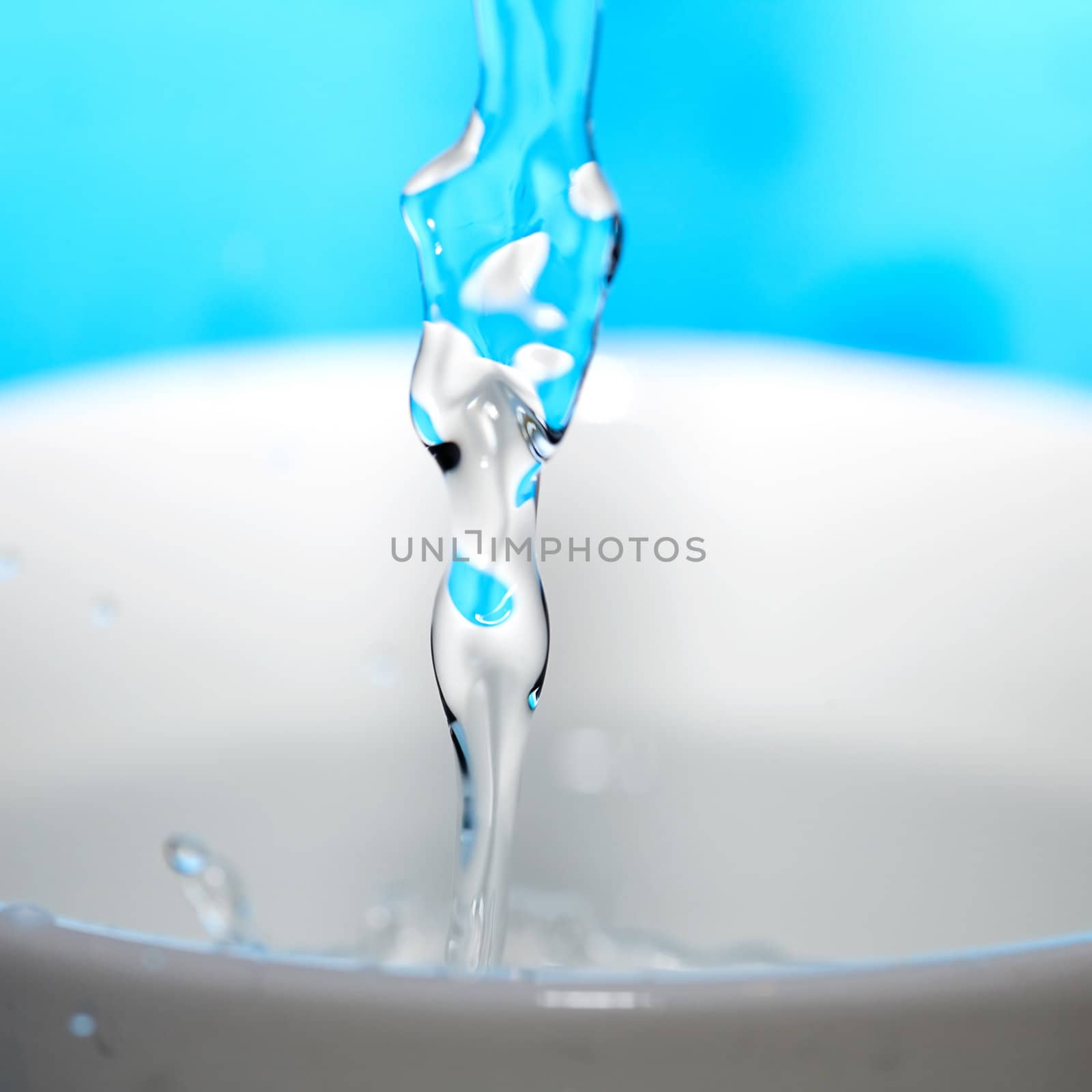 water splash in a cup on a blue background