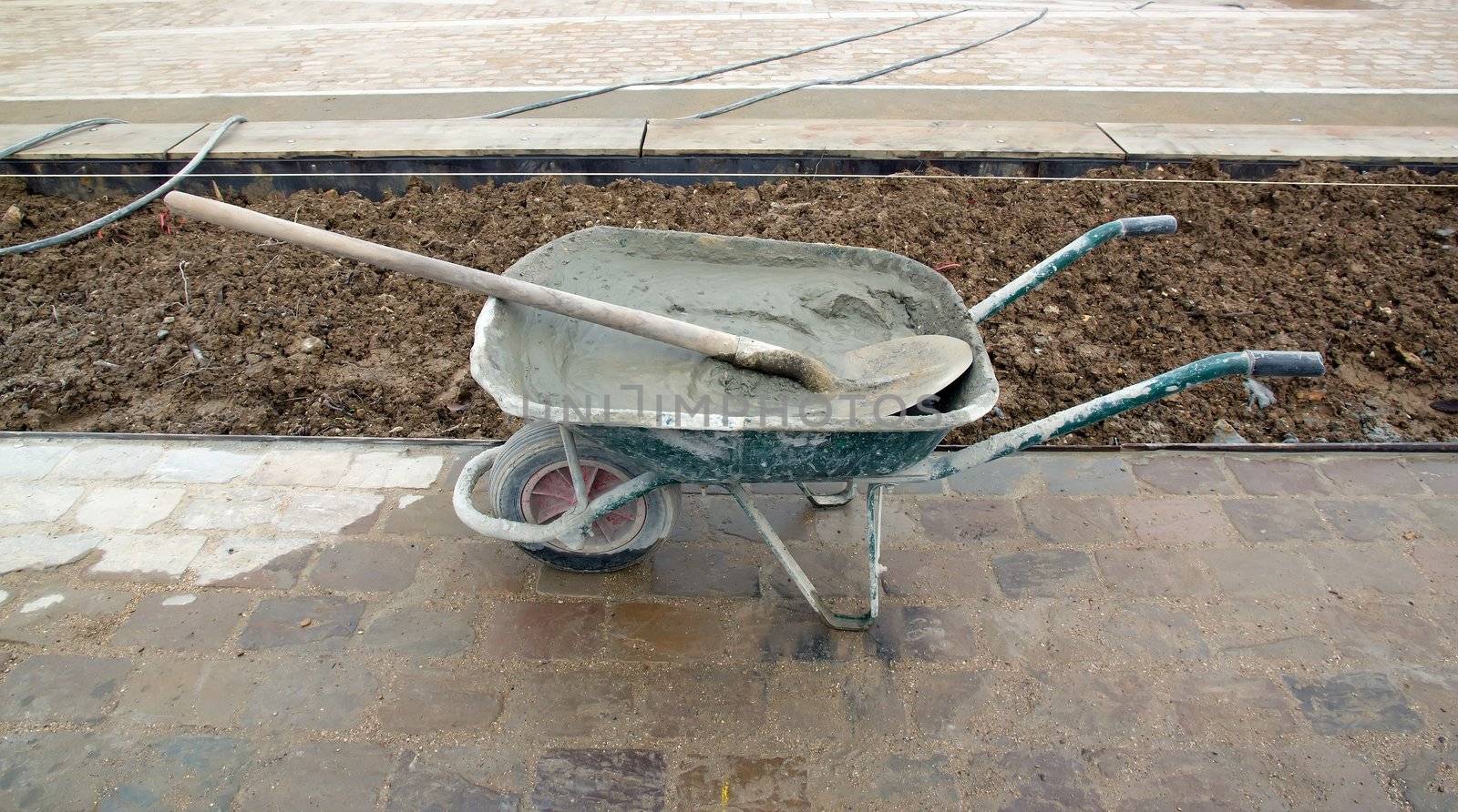 wheelbarrow filled with cement, construction site of public works by neko92vl