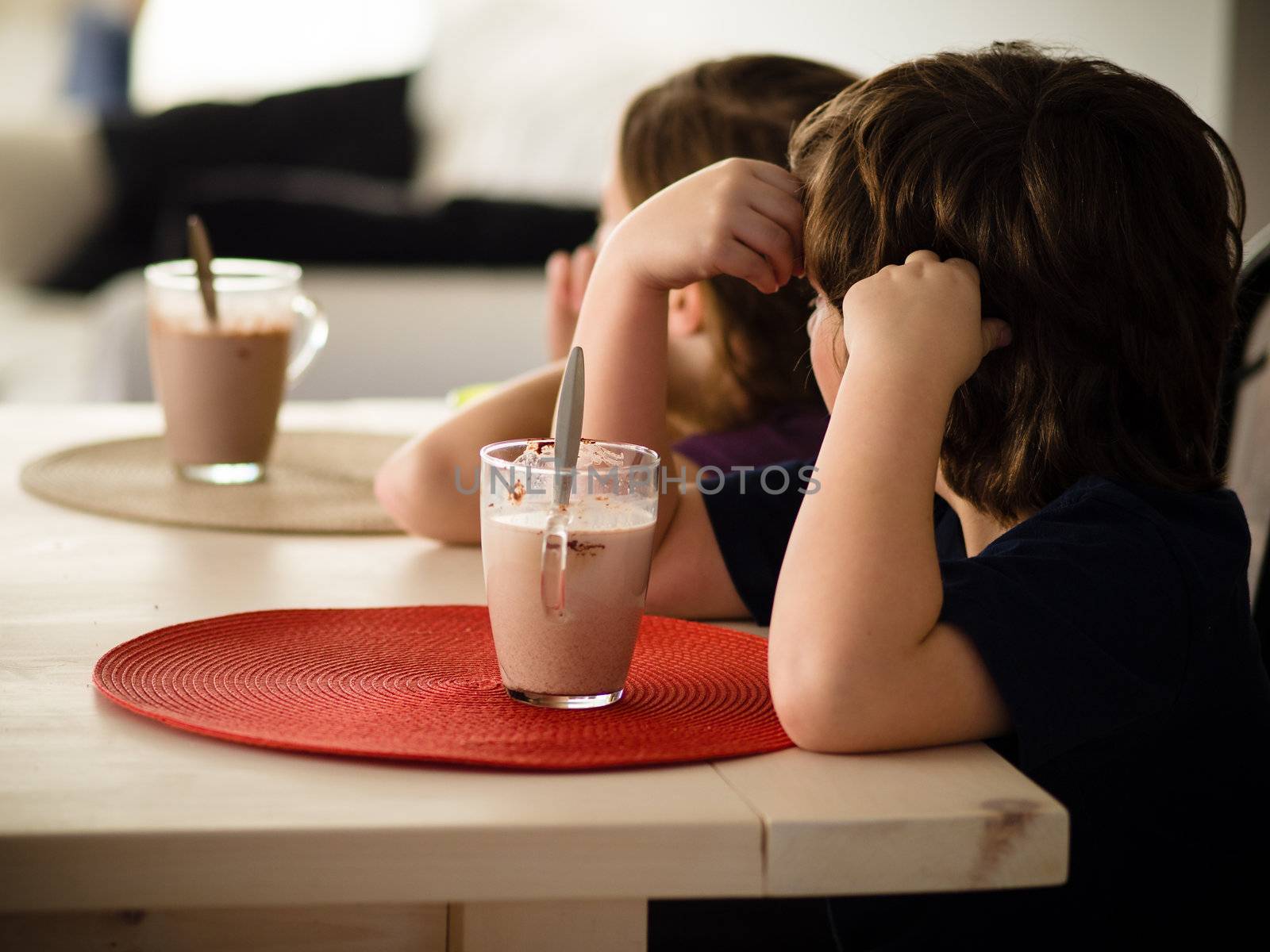 Children having a hot chocolate at the table