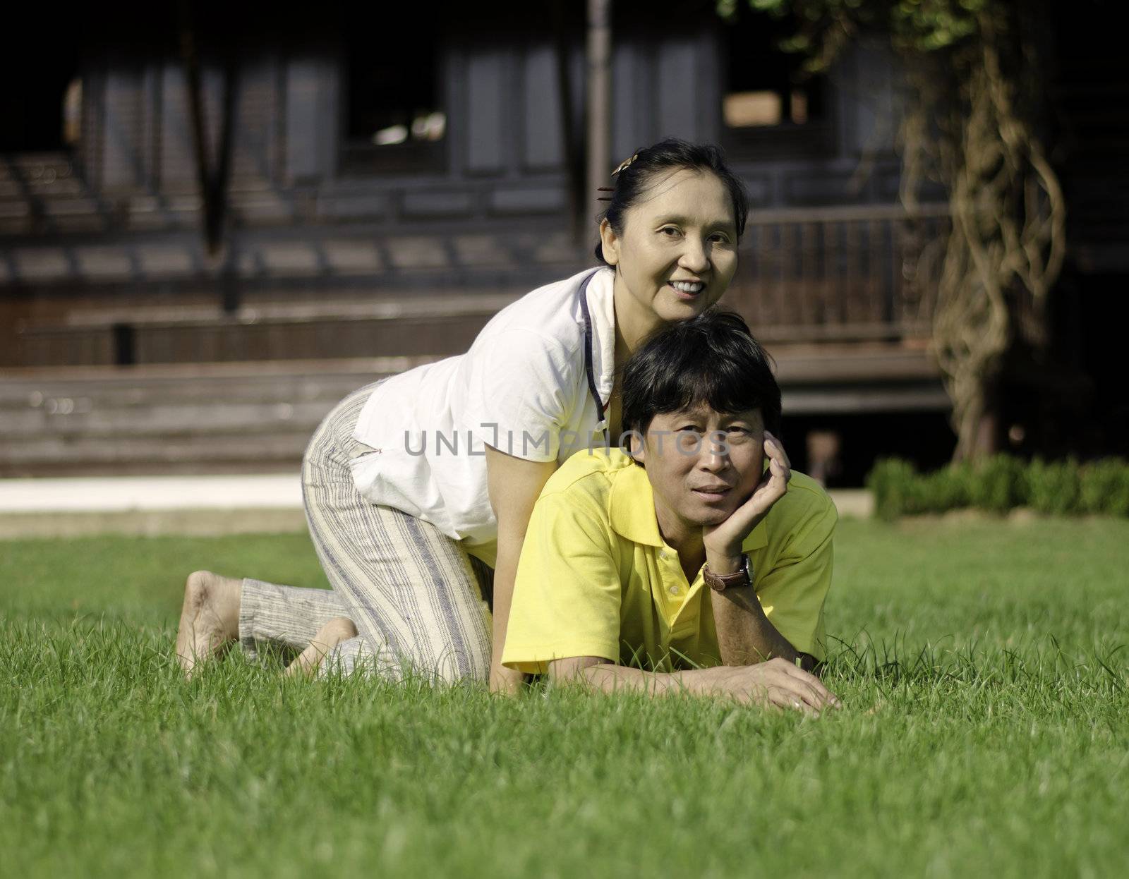 Beautiful senior couple in park by siraanamwong