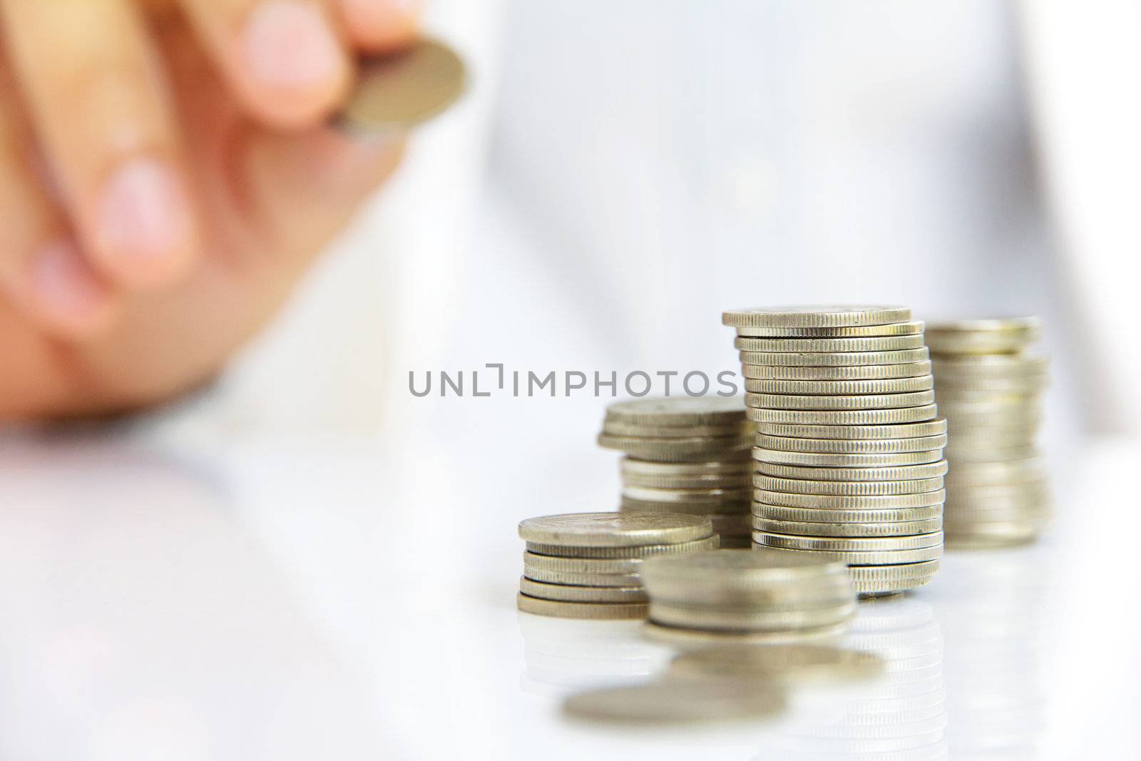 Hand put coin to stack by ponsulak